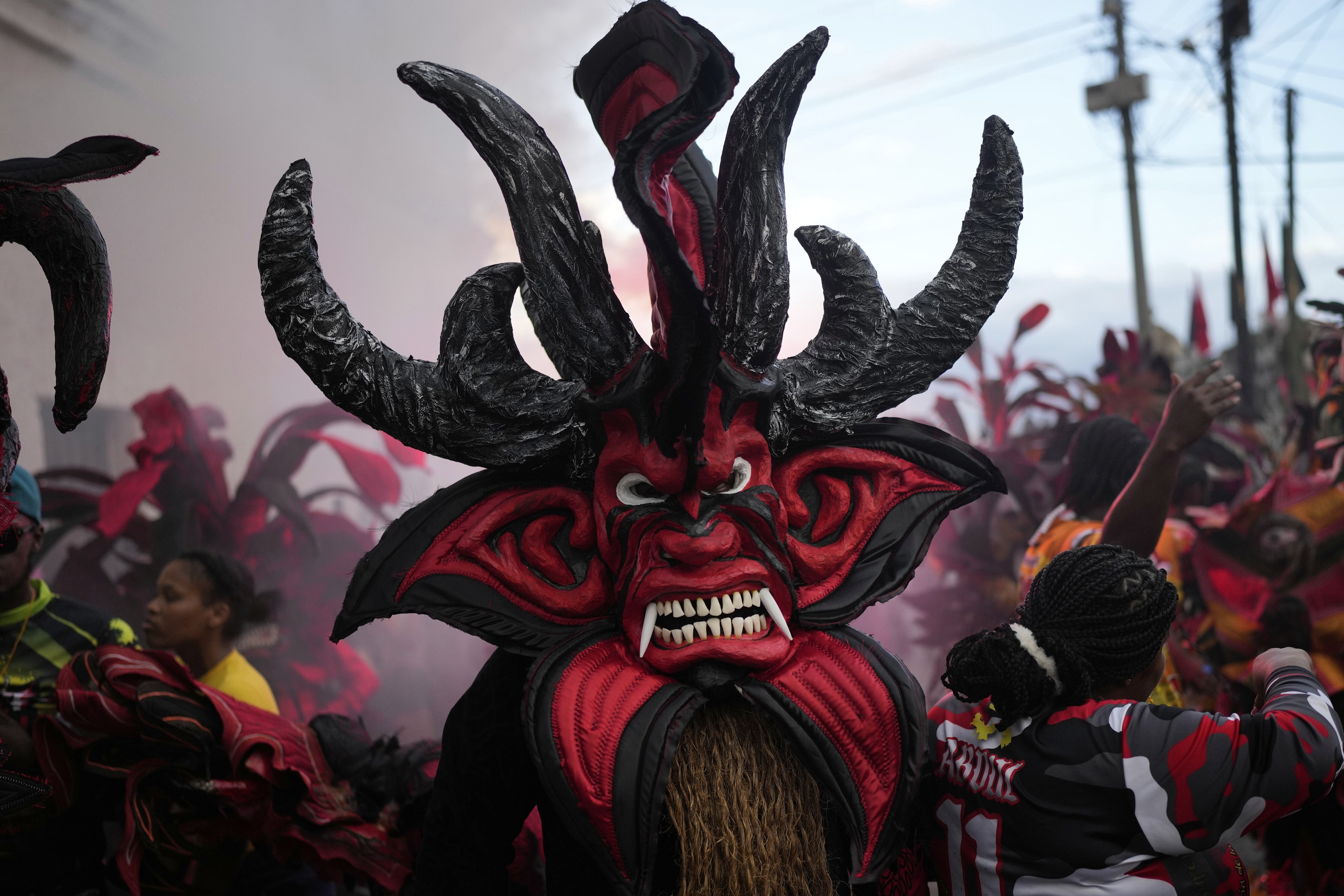 A person wears a frightening devil costume during a festival.