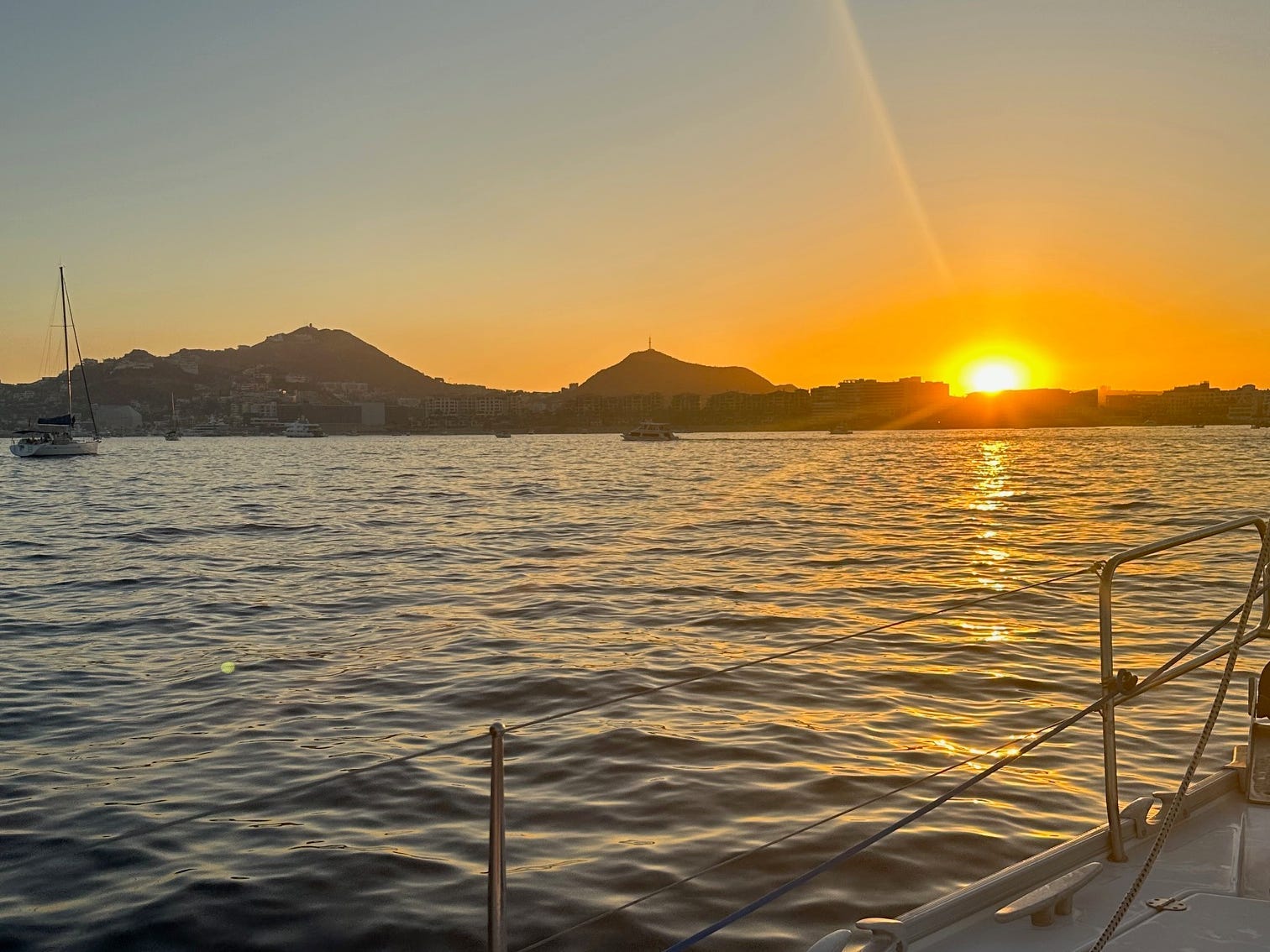 Sunset over water with mountains in distance