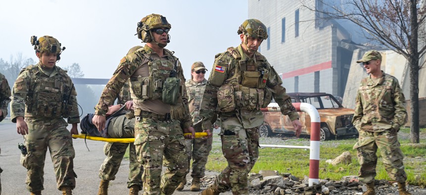 Members of the Georgia State Defense Force and U.S. airmen transport a role player with simulated injuries during Patriot 25 at Guardian Centers in Perry, Georgia, on March 25, 2025.