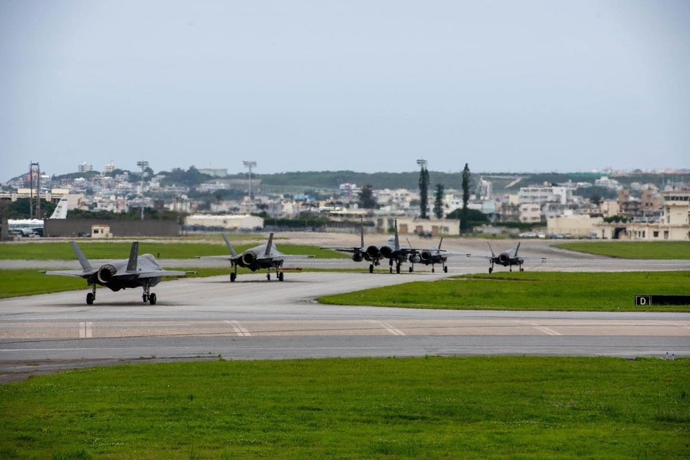 US Air Force aircraft line up on the flight line for an elephant walk during a routine readiness exercise at Kadena Air Base.