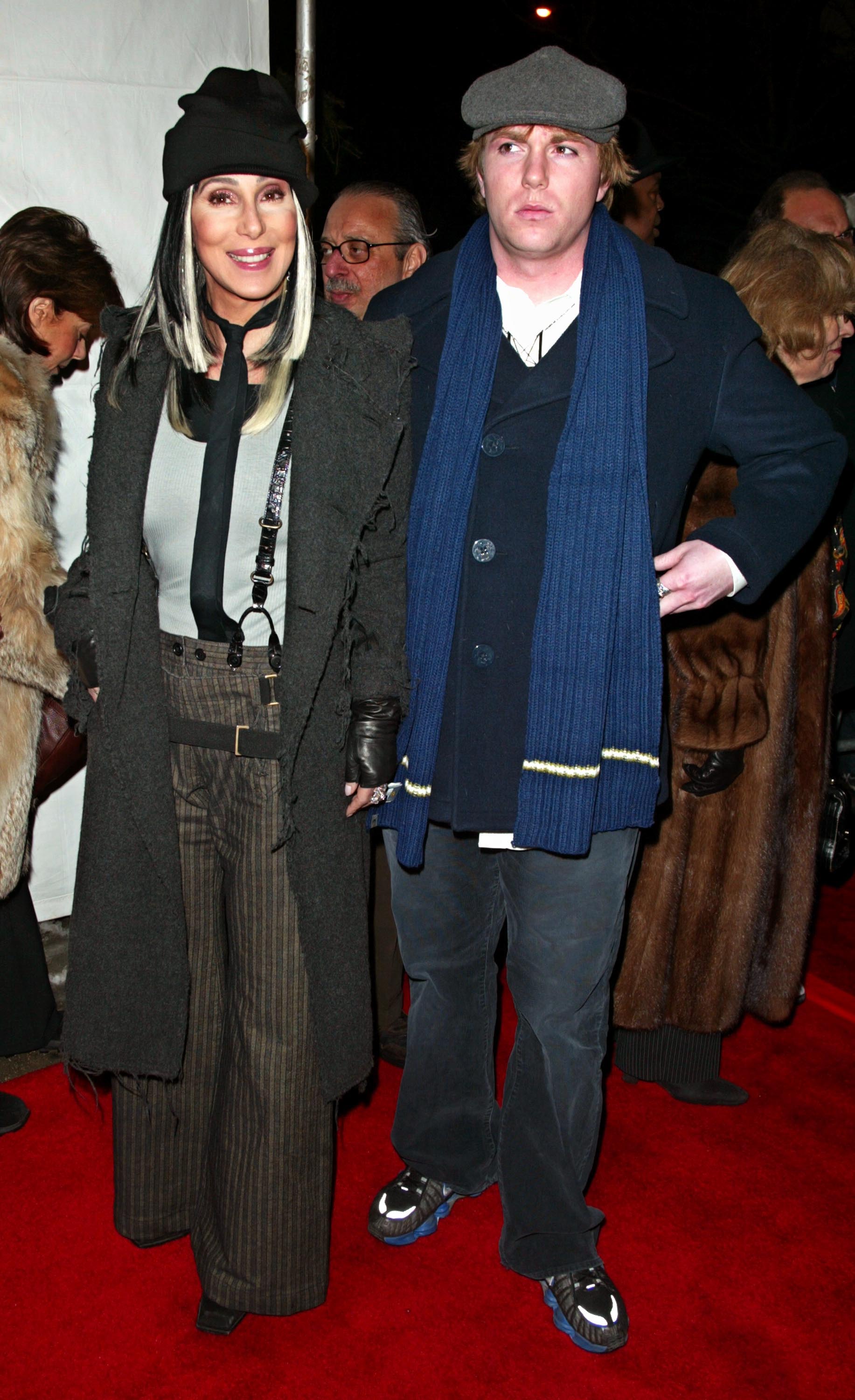 Cher and Elijah Blue Allman walk outdoors. 