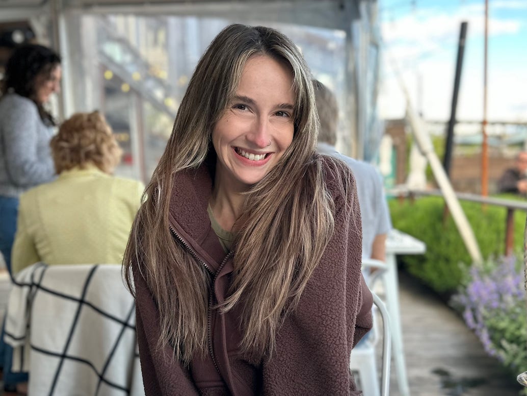 Amelia Samson sat at a table, smiling.