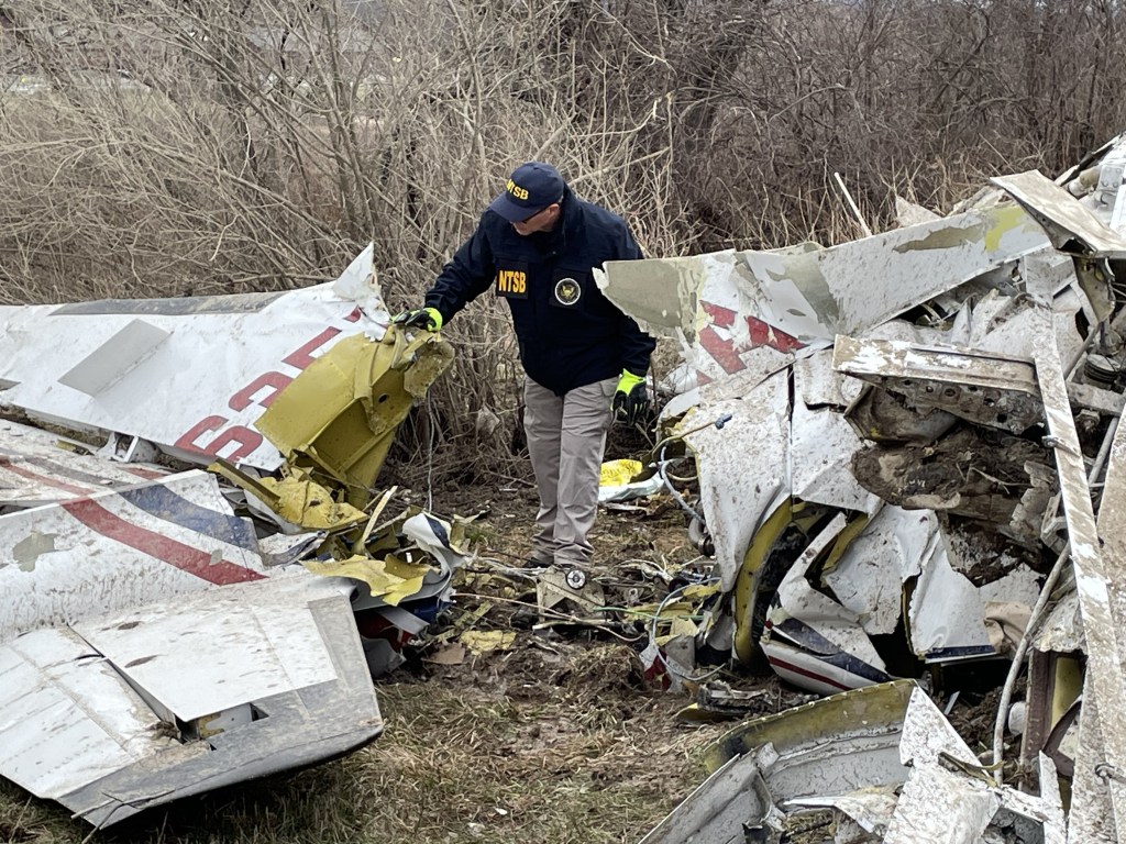 Officials search through the site of a deadly plane crash in Copake, New York on April 13, 2025.