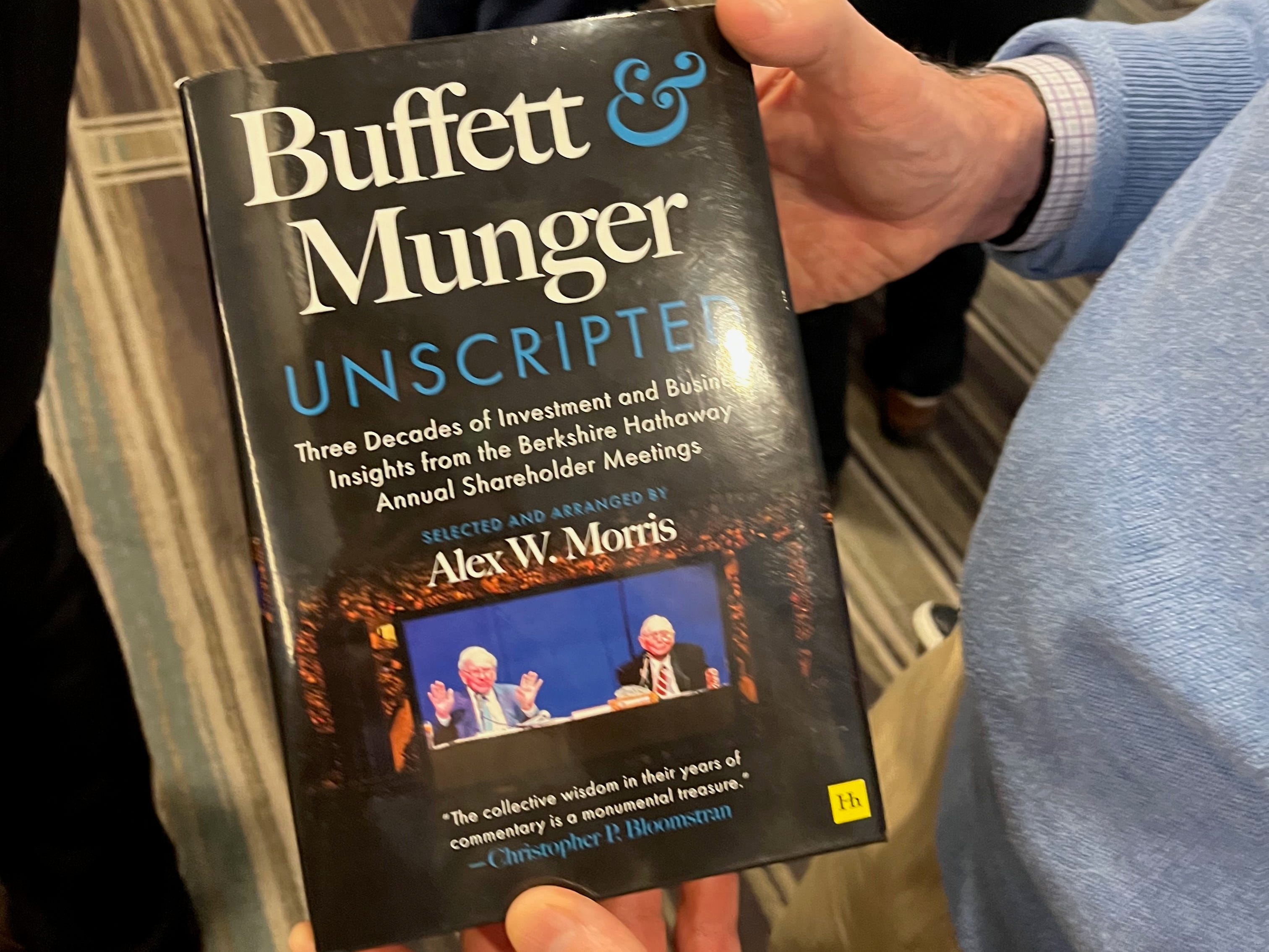 Martin Wiegand shows me his copy of "Buffett & Munger Unscripted."
