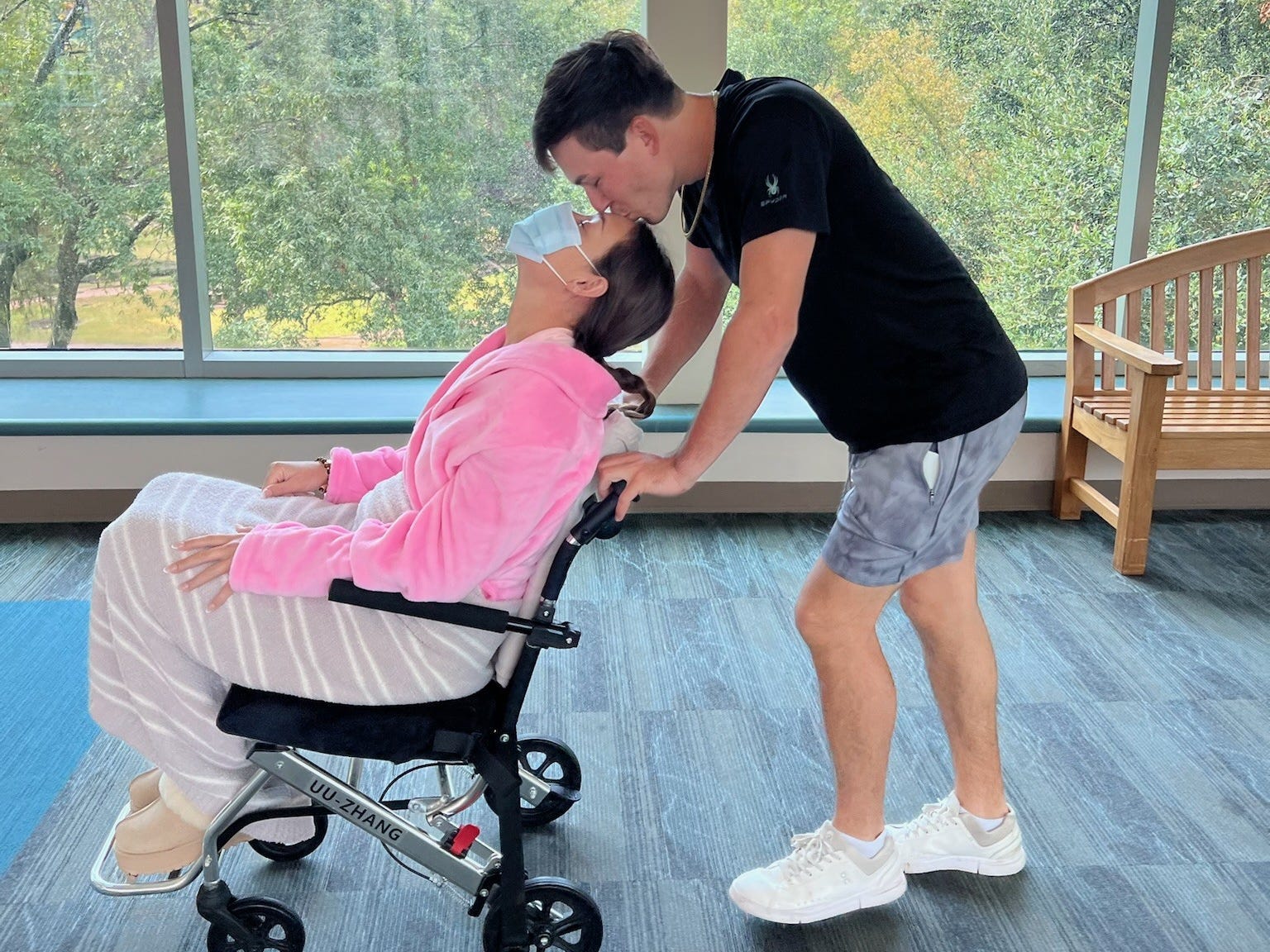 Breeze Hunter in a wheelchair, being pushed by her boyfriend.