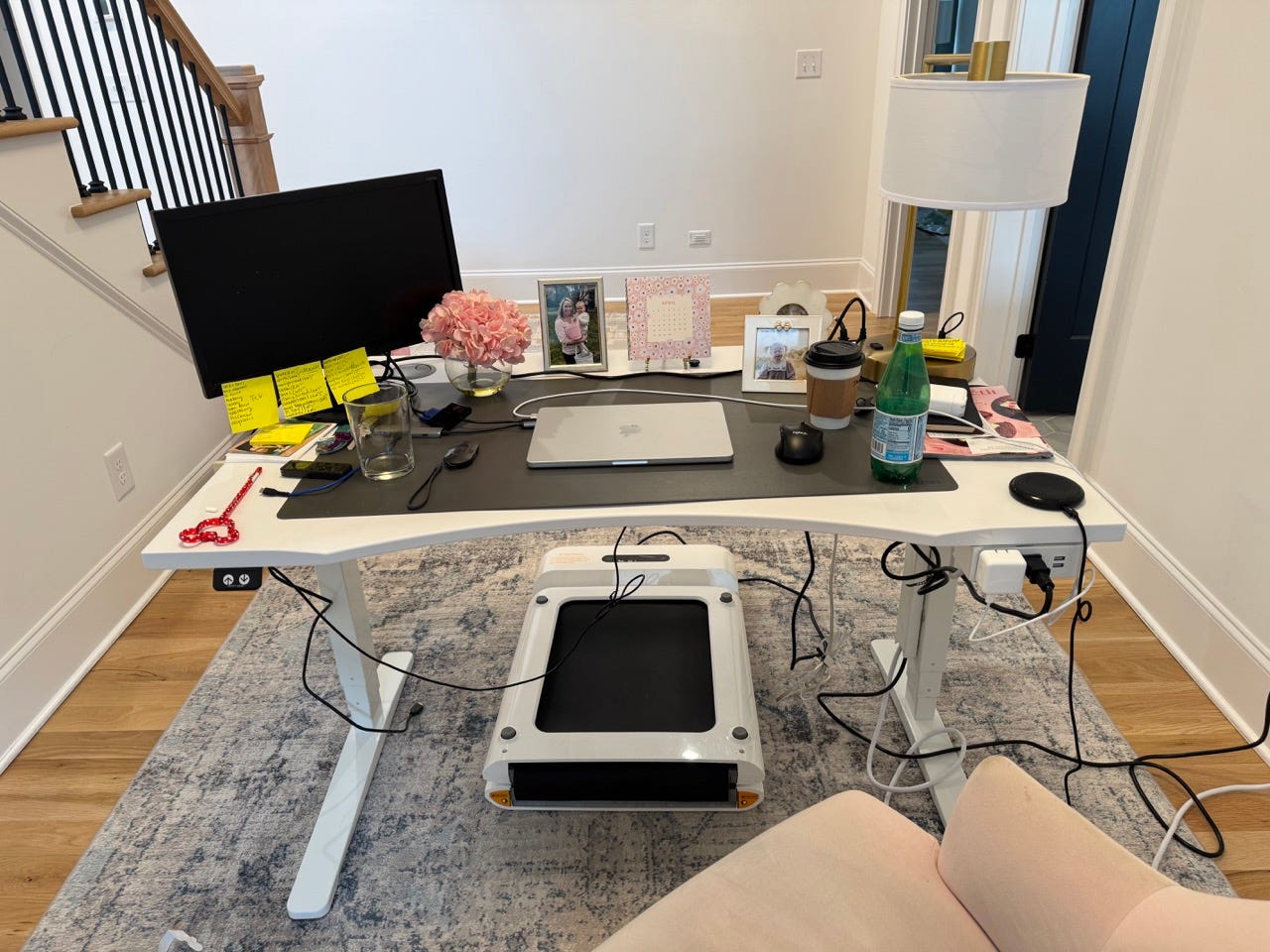 Walking pad below a raised desk