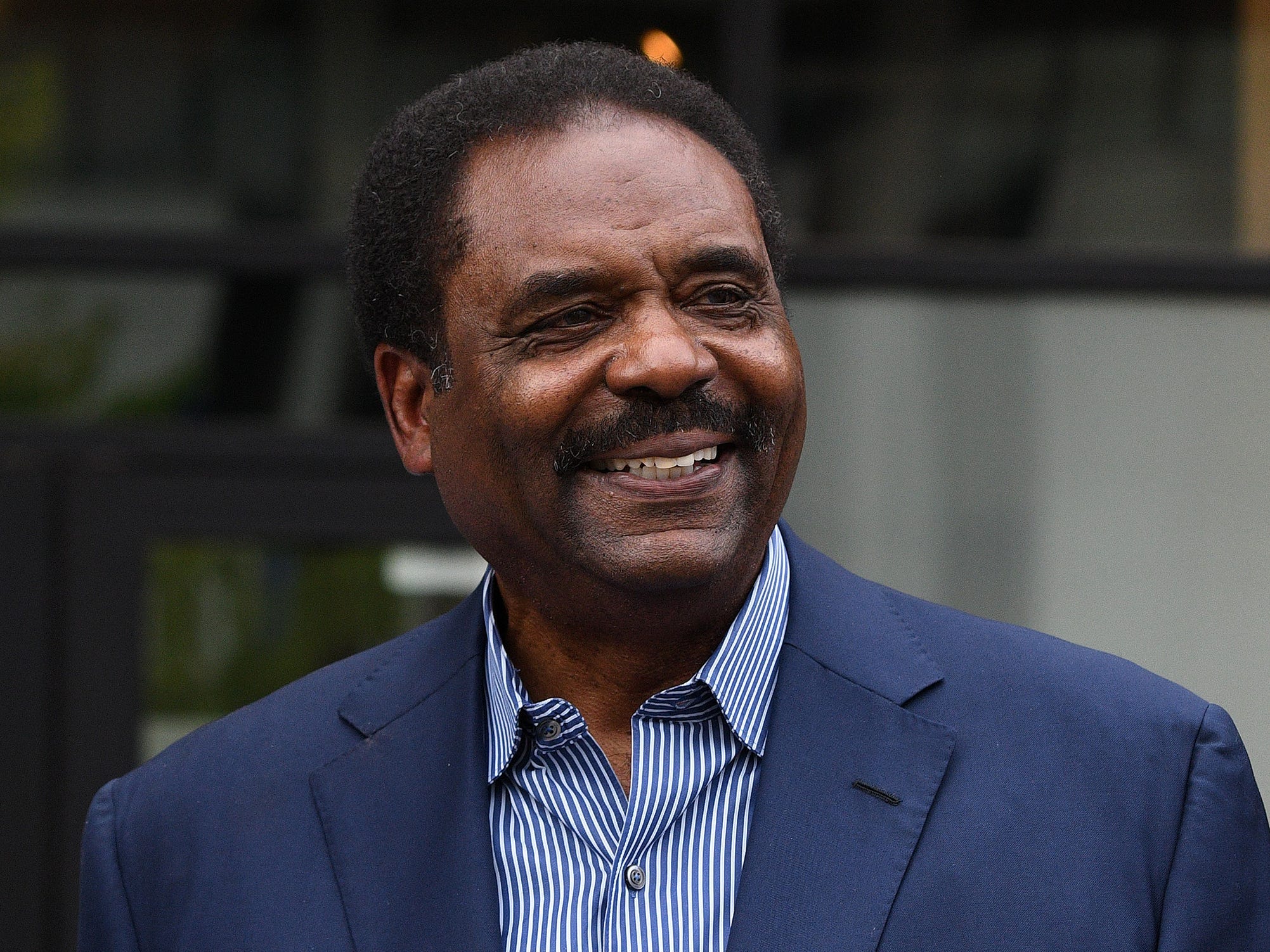 David Steward wearing a blue suit and blue-and-white striped shirt