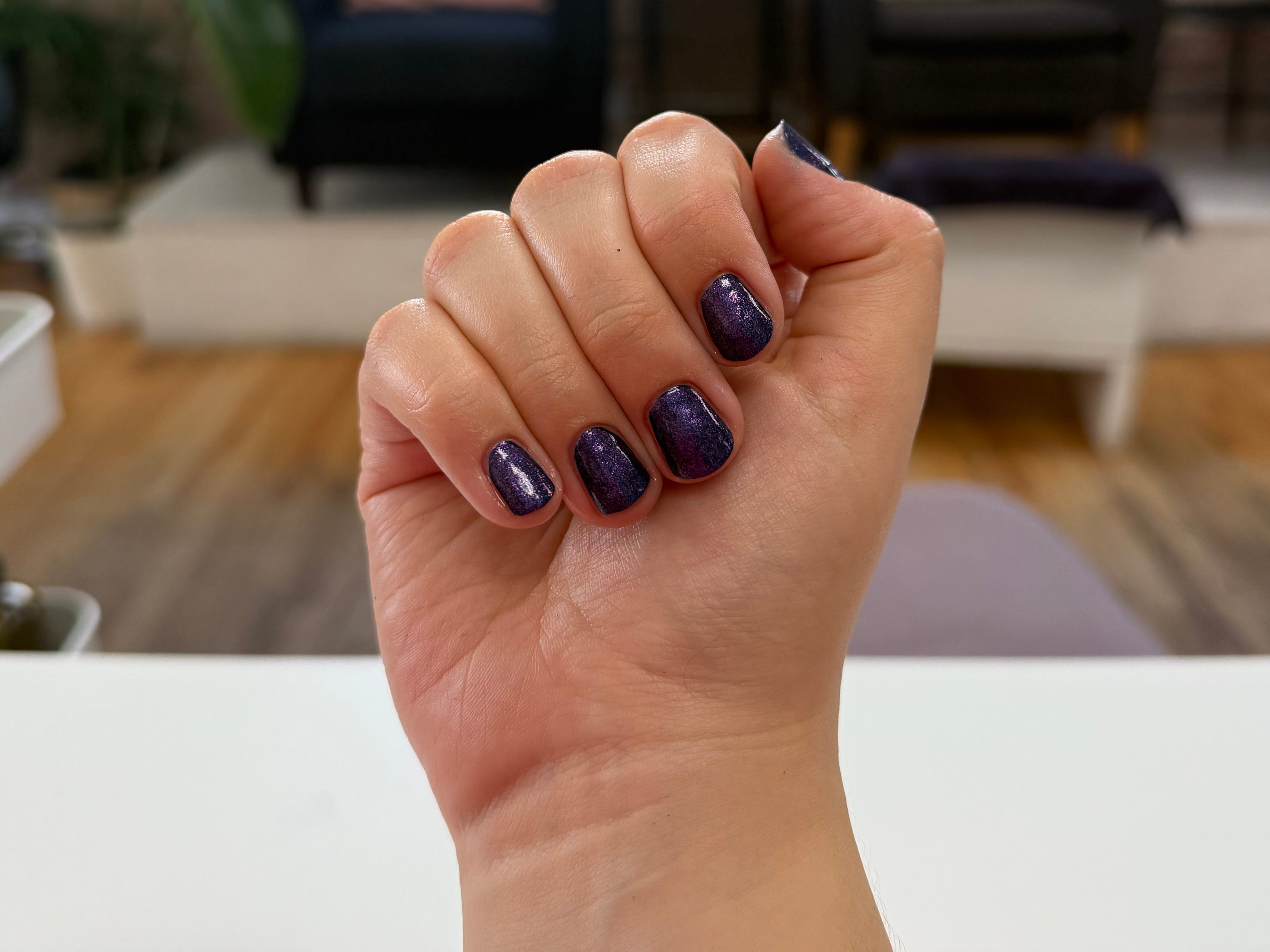 Gia's nails with sparkly purple nail polish.