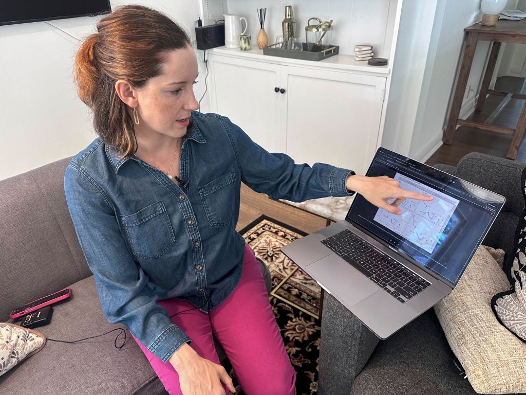 Georgia Tech linguist Lelia Glass points to a diagram showing how the pronunciation of certain words by metro-Atlanta residents has changed over several generations at her home in Atlanta, on Wednesday, April 30, 2025. 