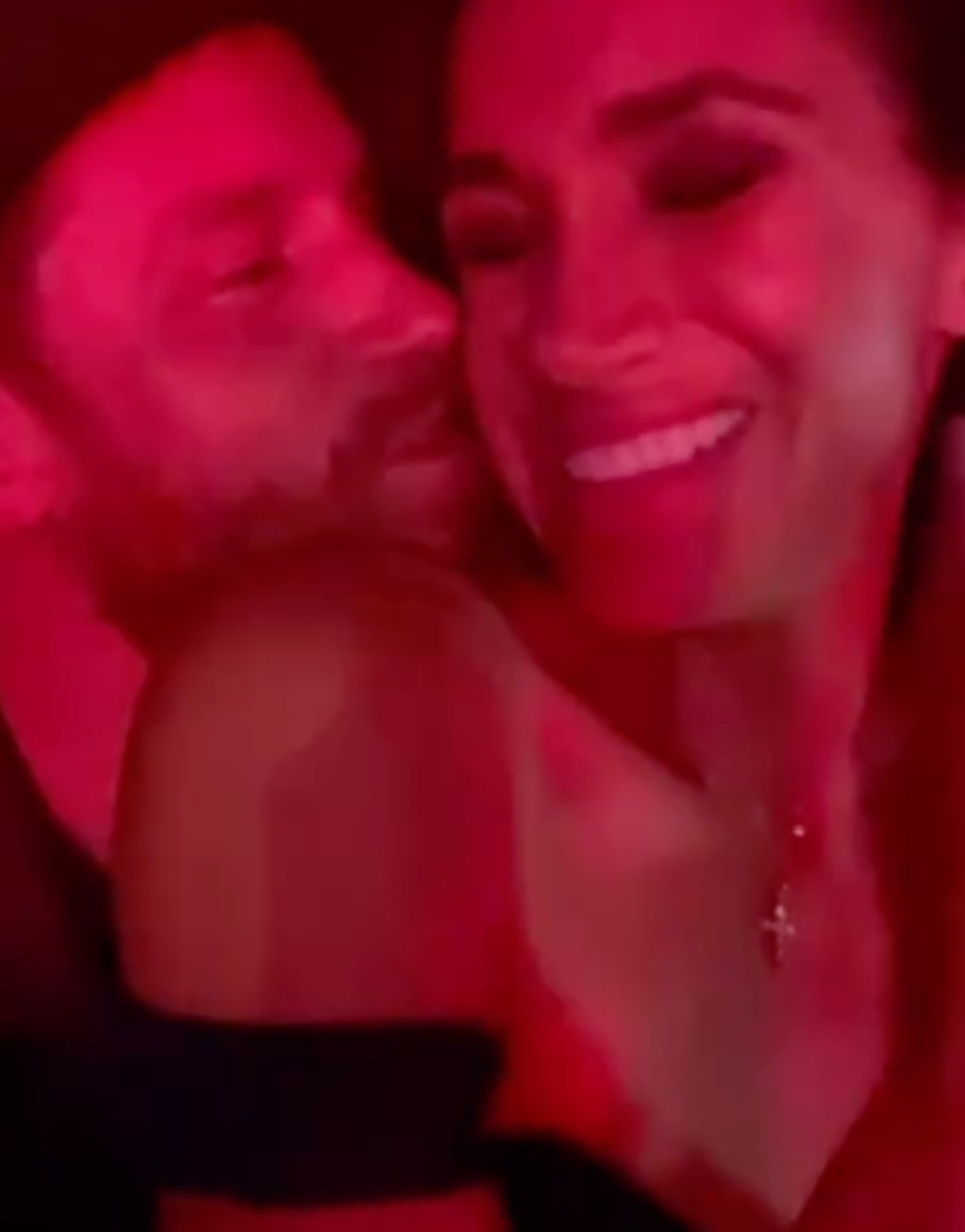 Prince Harry giving Meghan Markle a kiss.