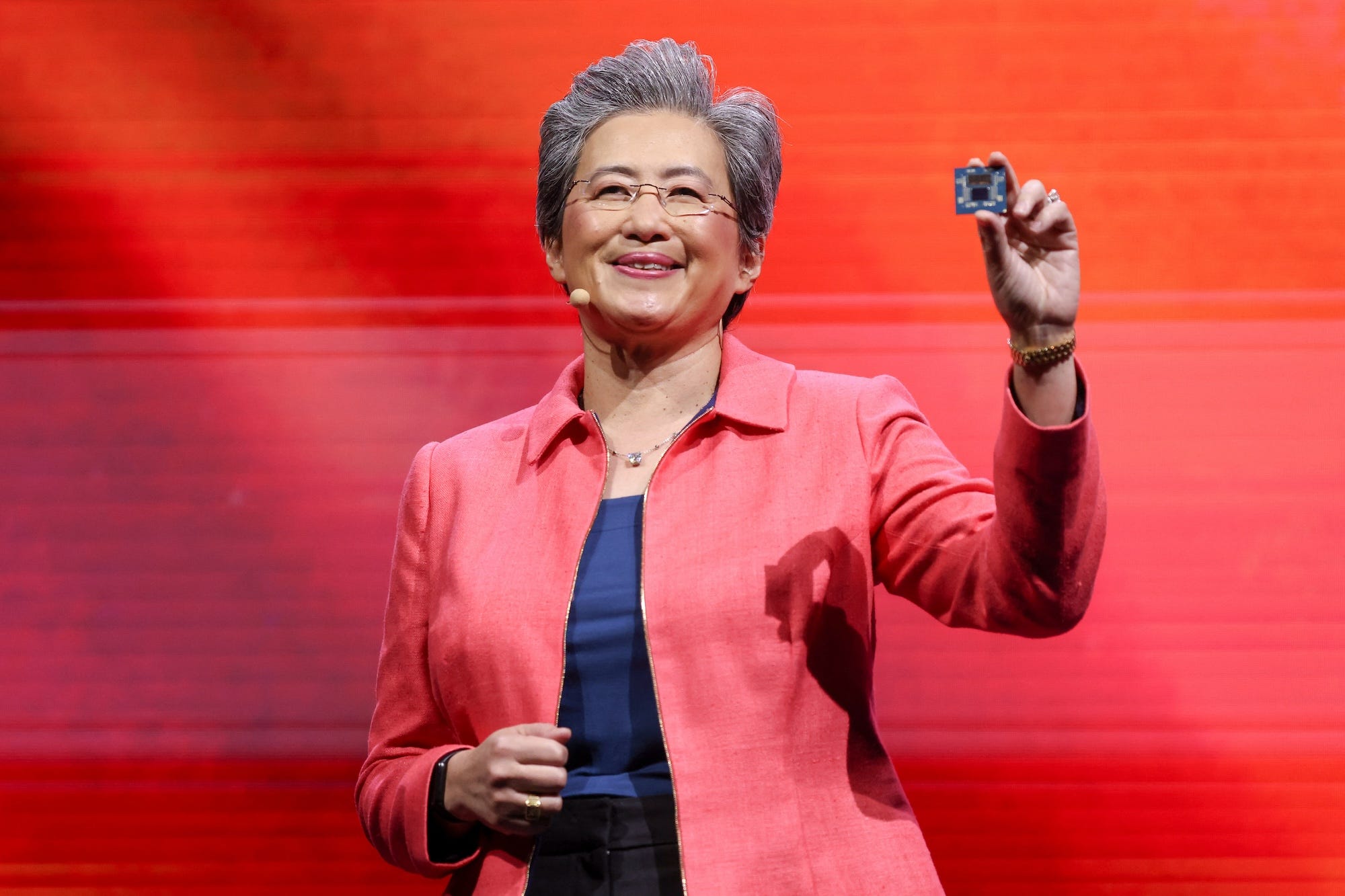 AMD CEO Lisa Su holds up one of the company's AI chips during a keynote speech.