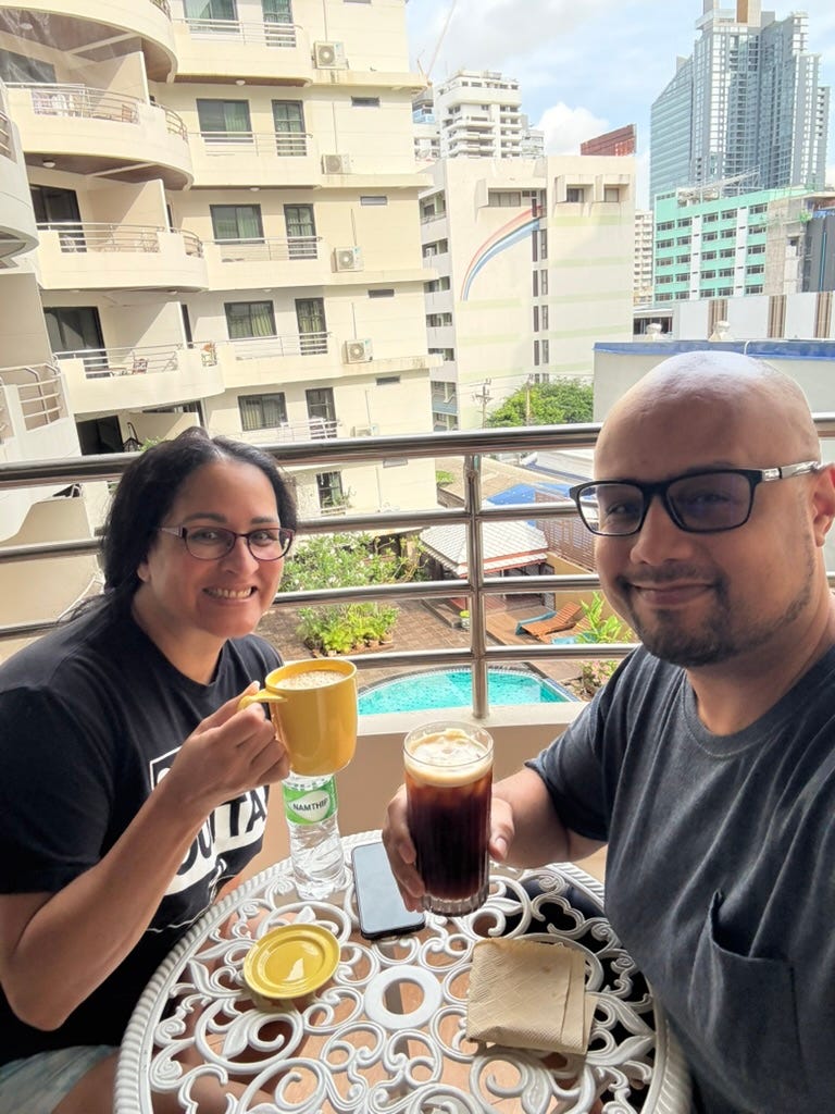 Kimanzi Constable and his wife drinking on their apartment terrace