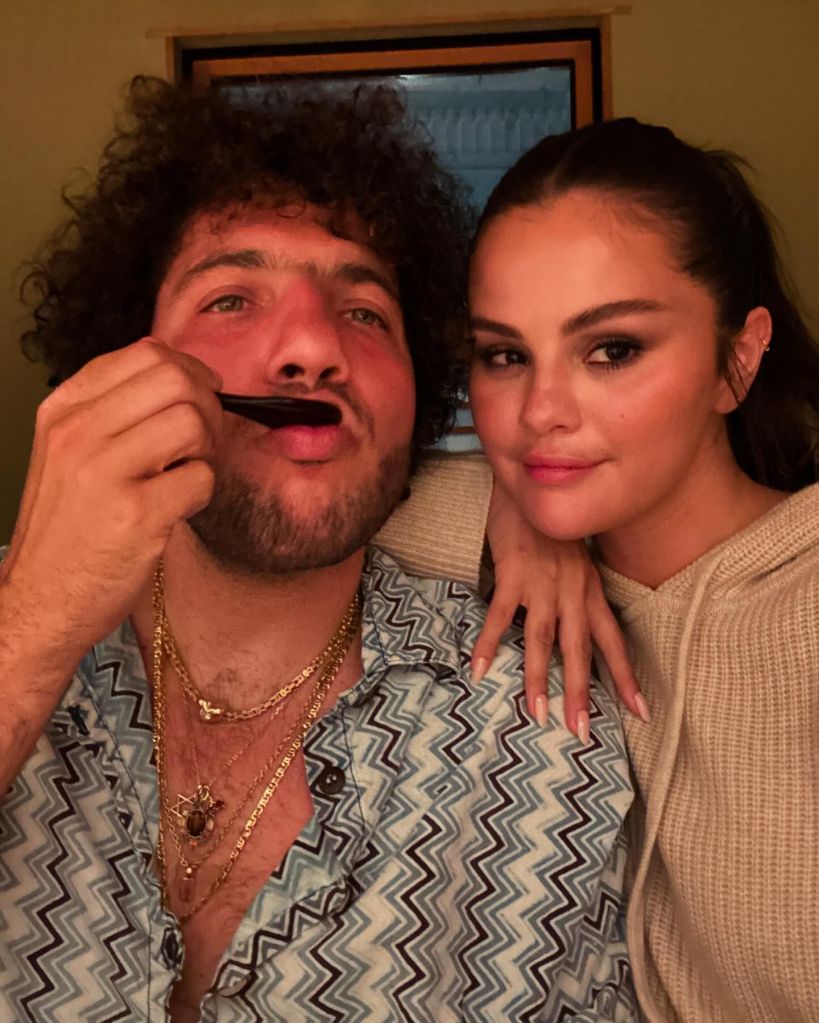 Selena Gomez and Benny Blanco pose for a photo.