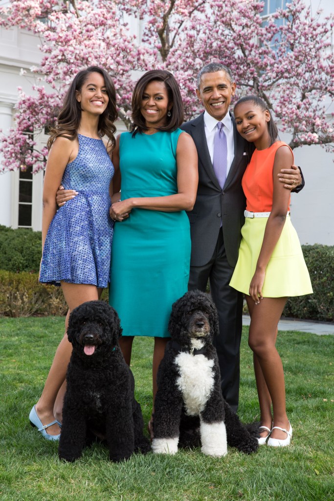 President Barack Obama, First Lady Michelle Obama, and daughters Malia (L) and Sasha (R) pose for a family portrait with their pets Bo and Sunny in the Rose Garden of the White House on Easter Sunday, April 5, 2015 in Washington, DC. 