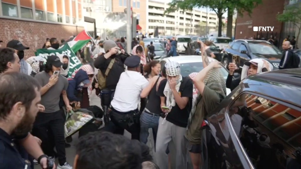 Police clashing with protesters, including Elandon Roberts and Jonathan Cyprien, outside of Brooklyn CUNY College following a raid, with one protester being tasered three times.