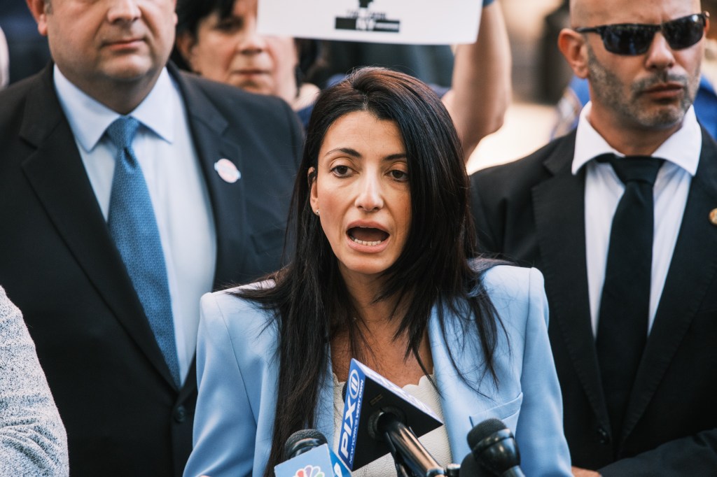 Councilwoman Inna Vernikov speaking at a press conference, calling for the resignation of Cooper Union President Laura Sparks, next to Lawyer Gerard Filitti announcing a lawsuit by Jewish students.
