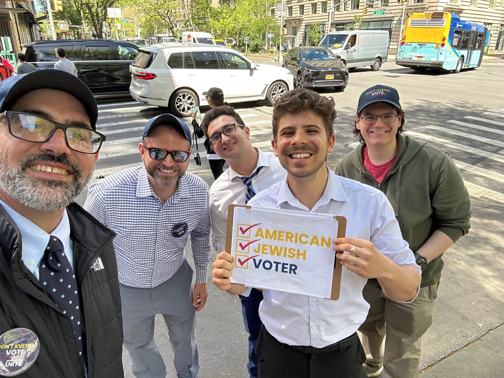 Maury Litwack, founder of Jewish Voters Unite, wearing a black button, standing second from left among other canvassers