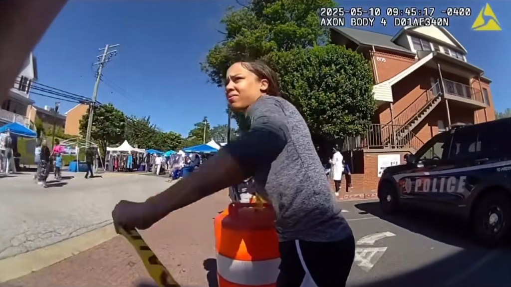 Kai DeBerry-Bostick tears down police tape.