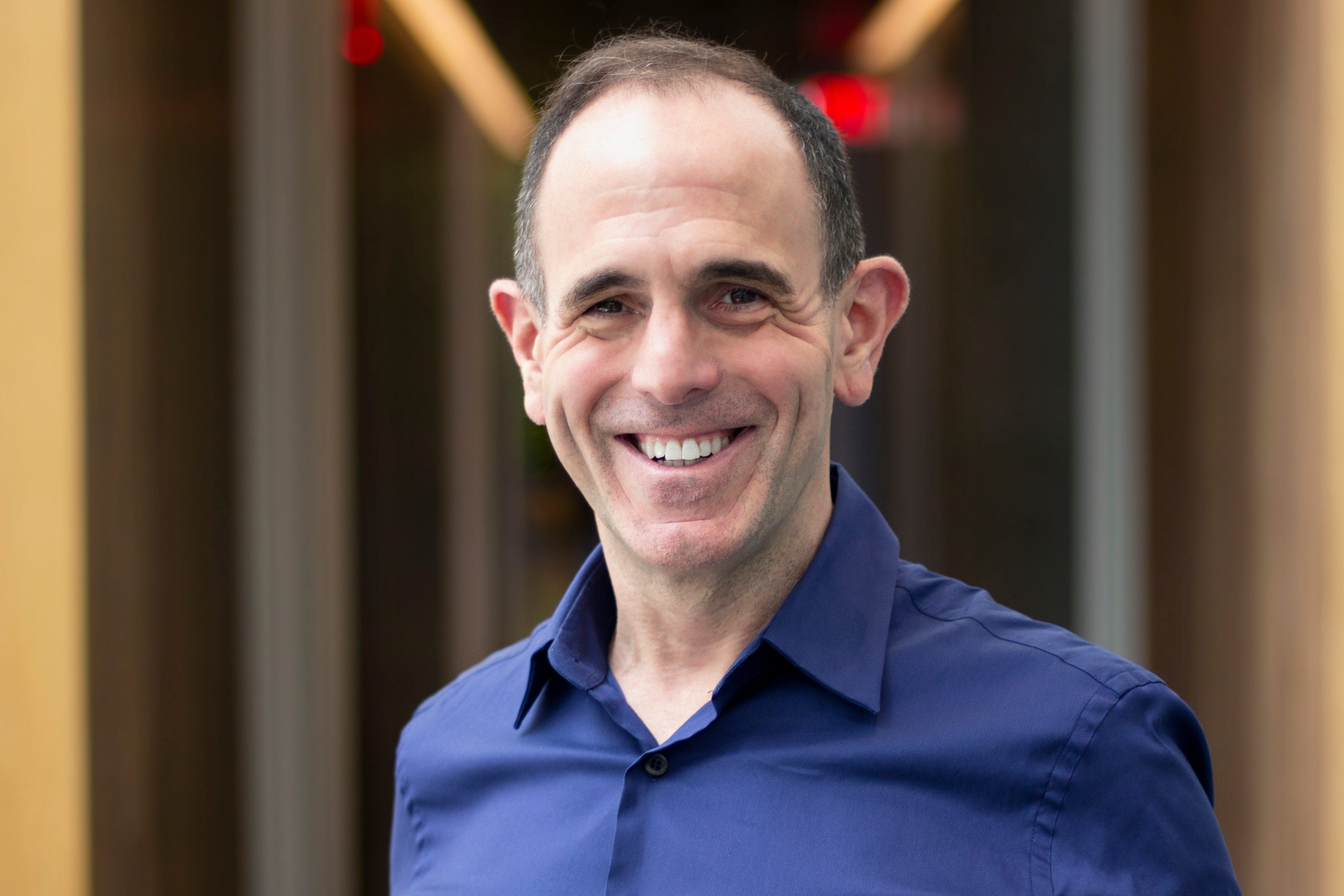 Keith Rabois standing in a library.