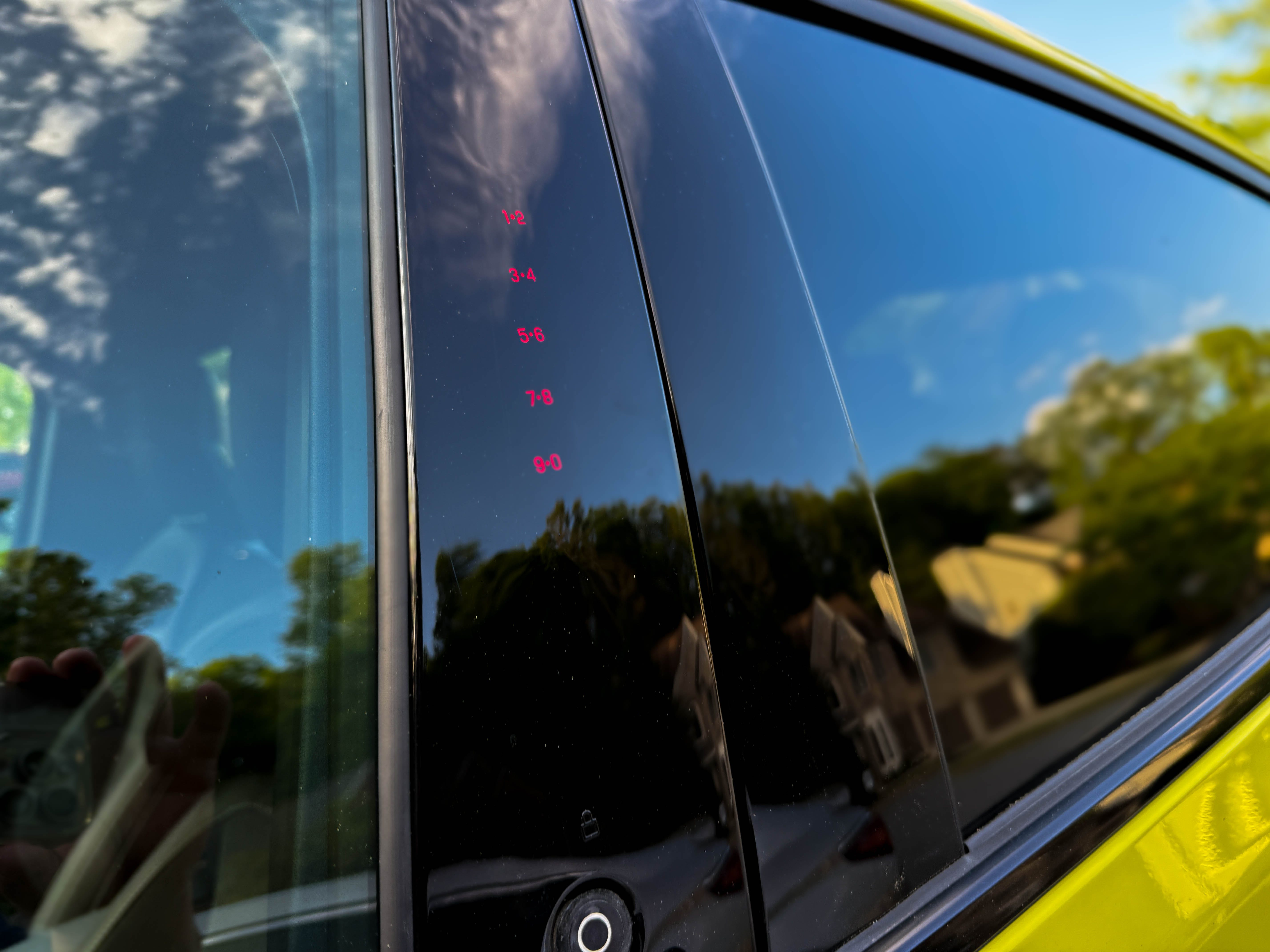 The SecuriCode keyless entry keypad on the driver's door of a yellow 2025 Ford Mustang Mach-E Rally EV SUV.