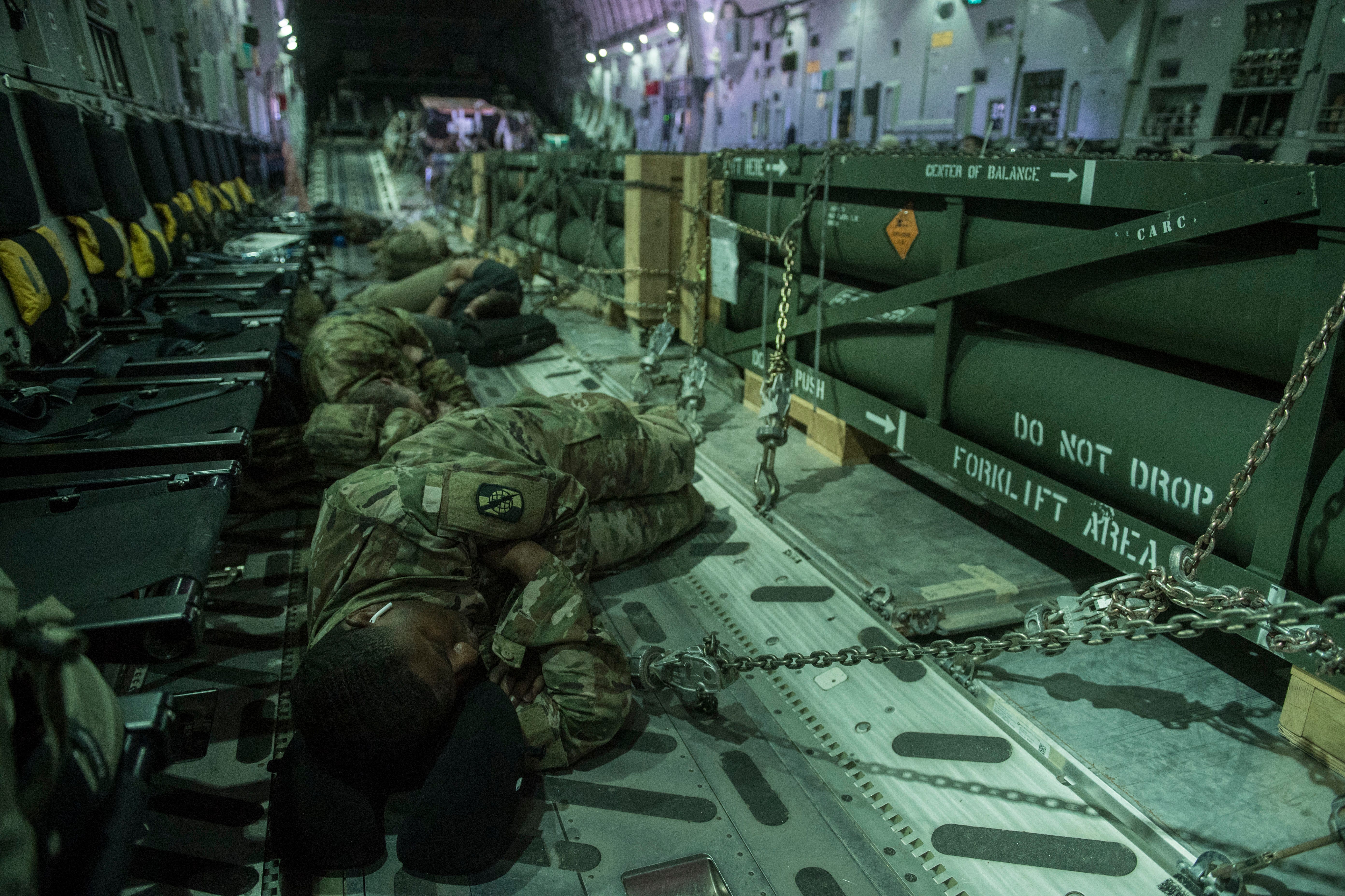 U.S. soldiers sleep on the floor of a C-17 Globemaster III, Aug. 17, 2019.
