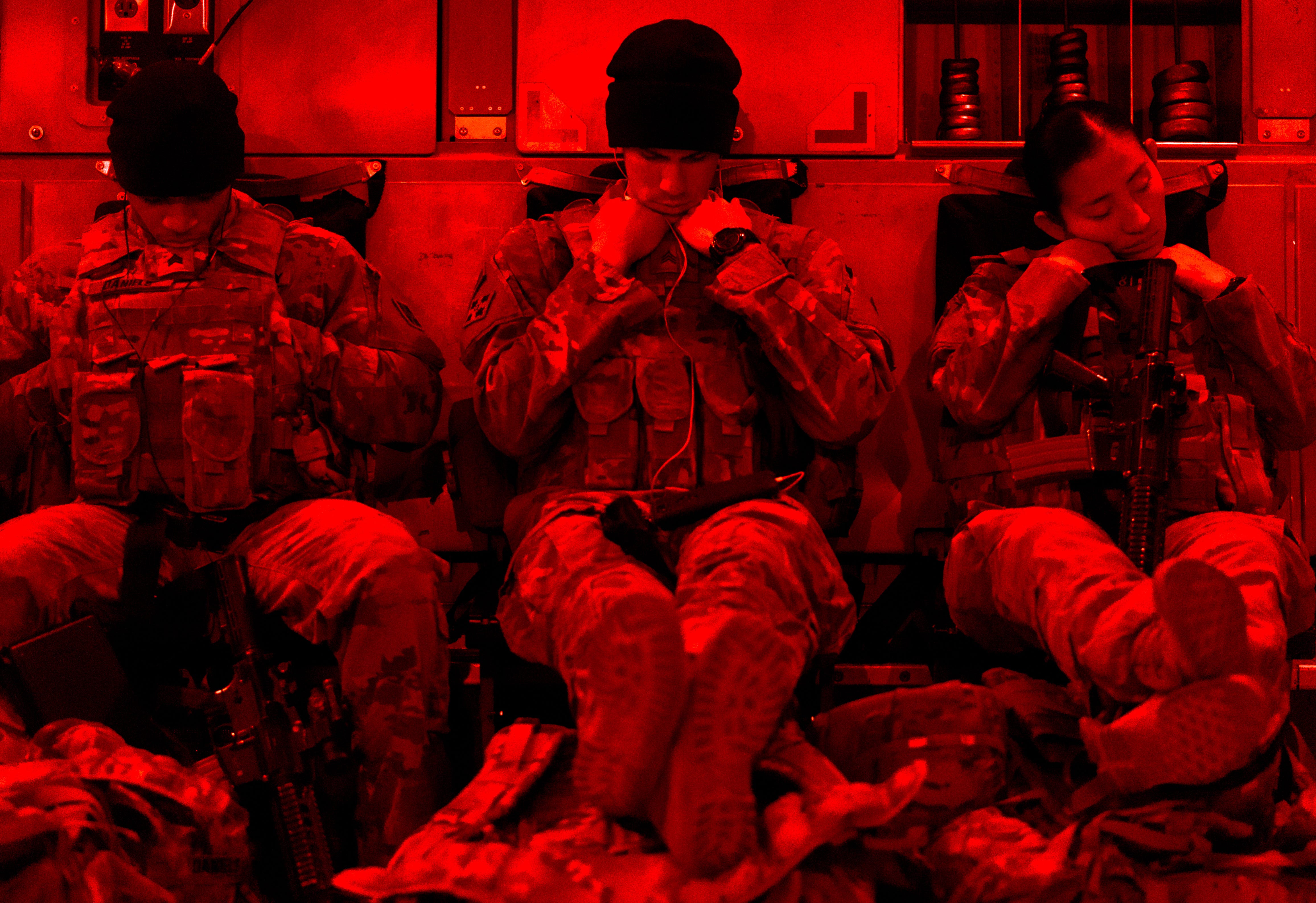 U.S. soldiers sleep on a C-17 Globemaster III during a redeployment flight from Afghanistan, Dec. 7, 2018.