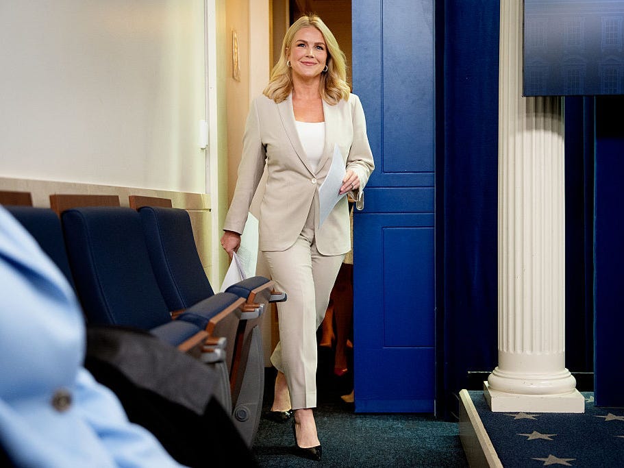 Karoline Leavitt in a stone suit designed by Chris Cuozzo.