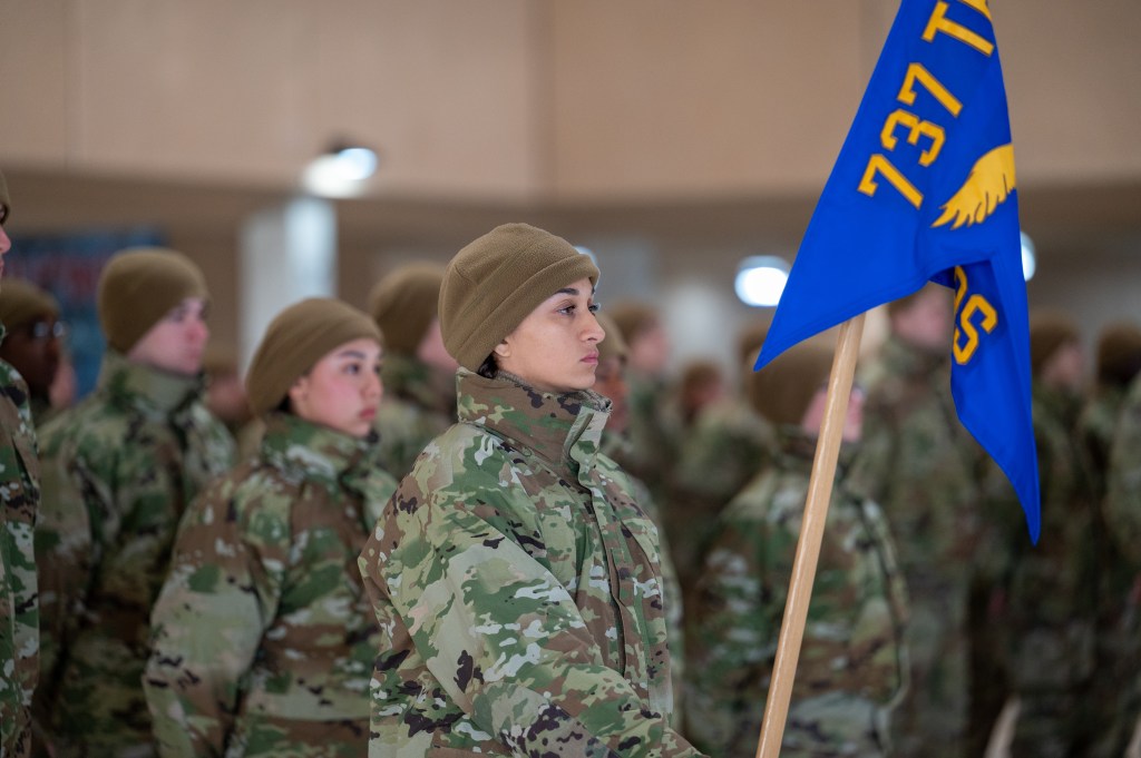 Anita Alvarez holding guidon during basic military training ceremony