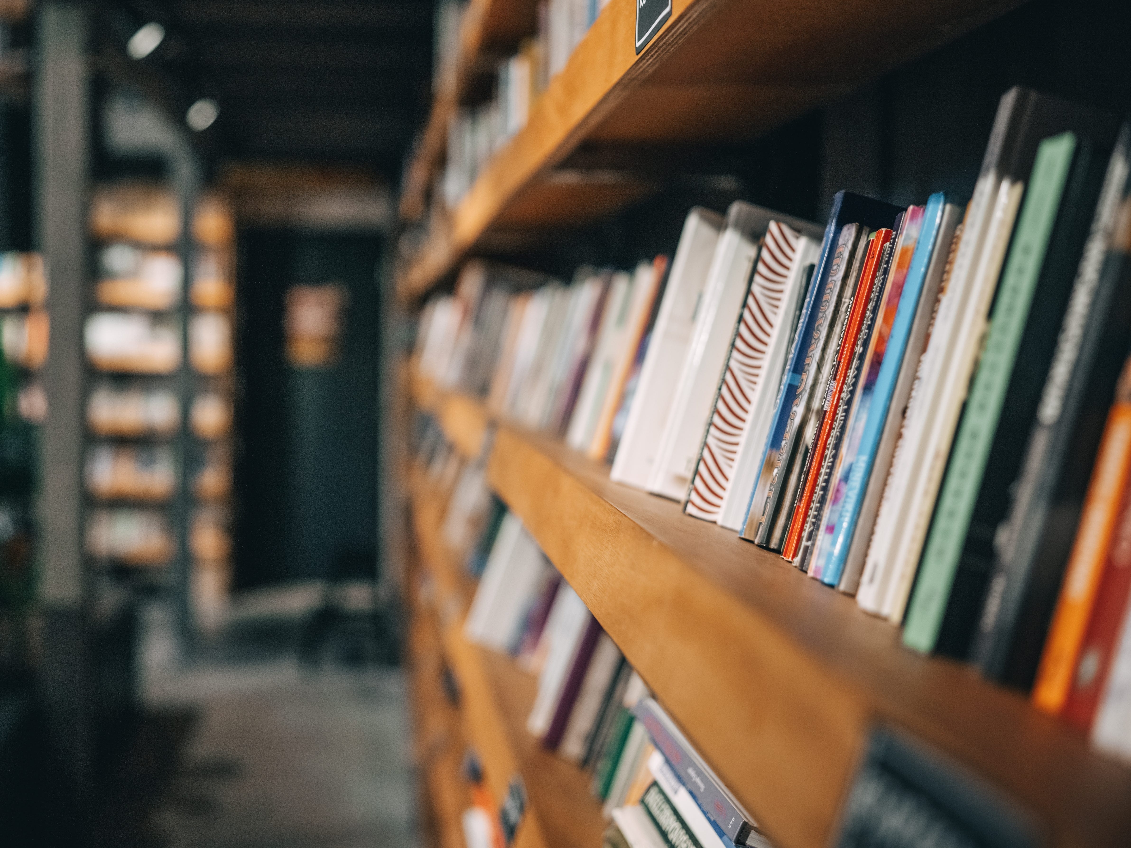 A wall of bookshelves in a library.