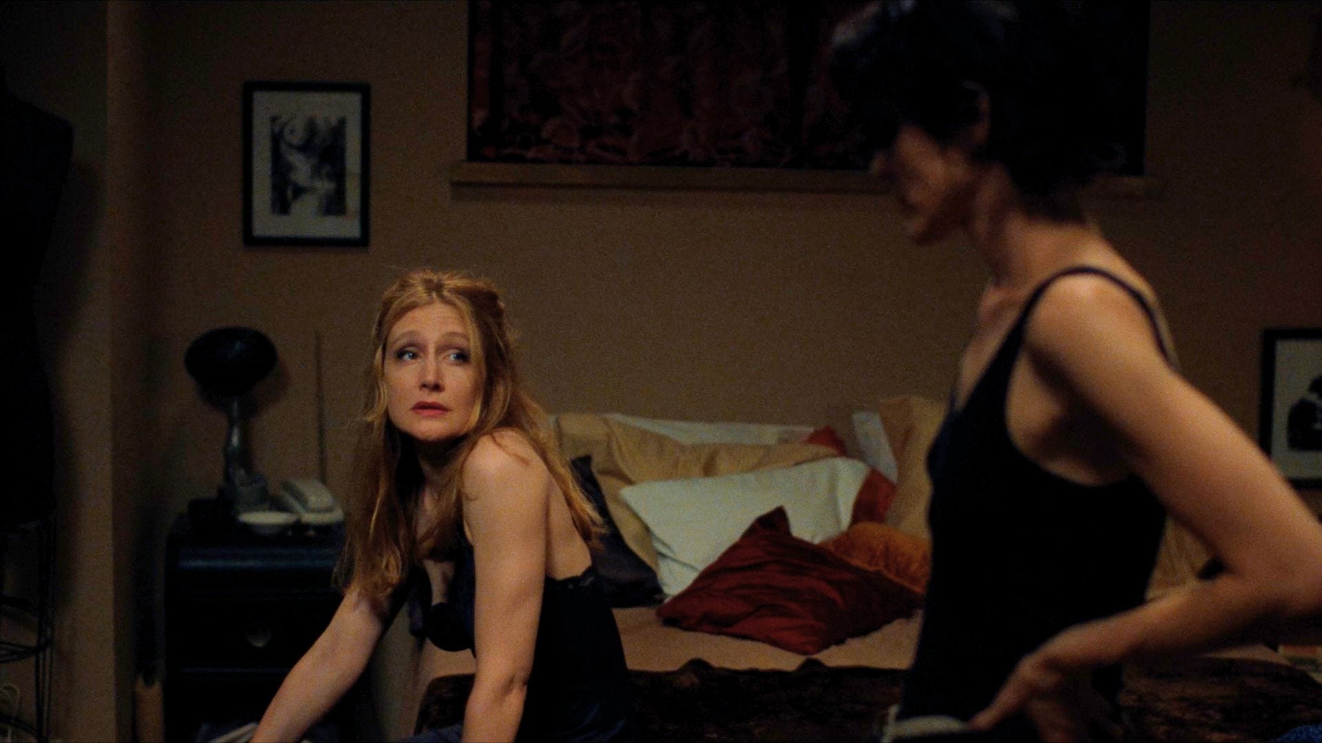 Patricia Clarkson sitting on a bed