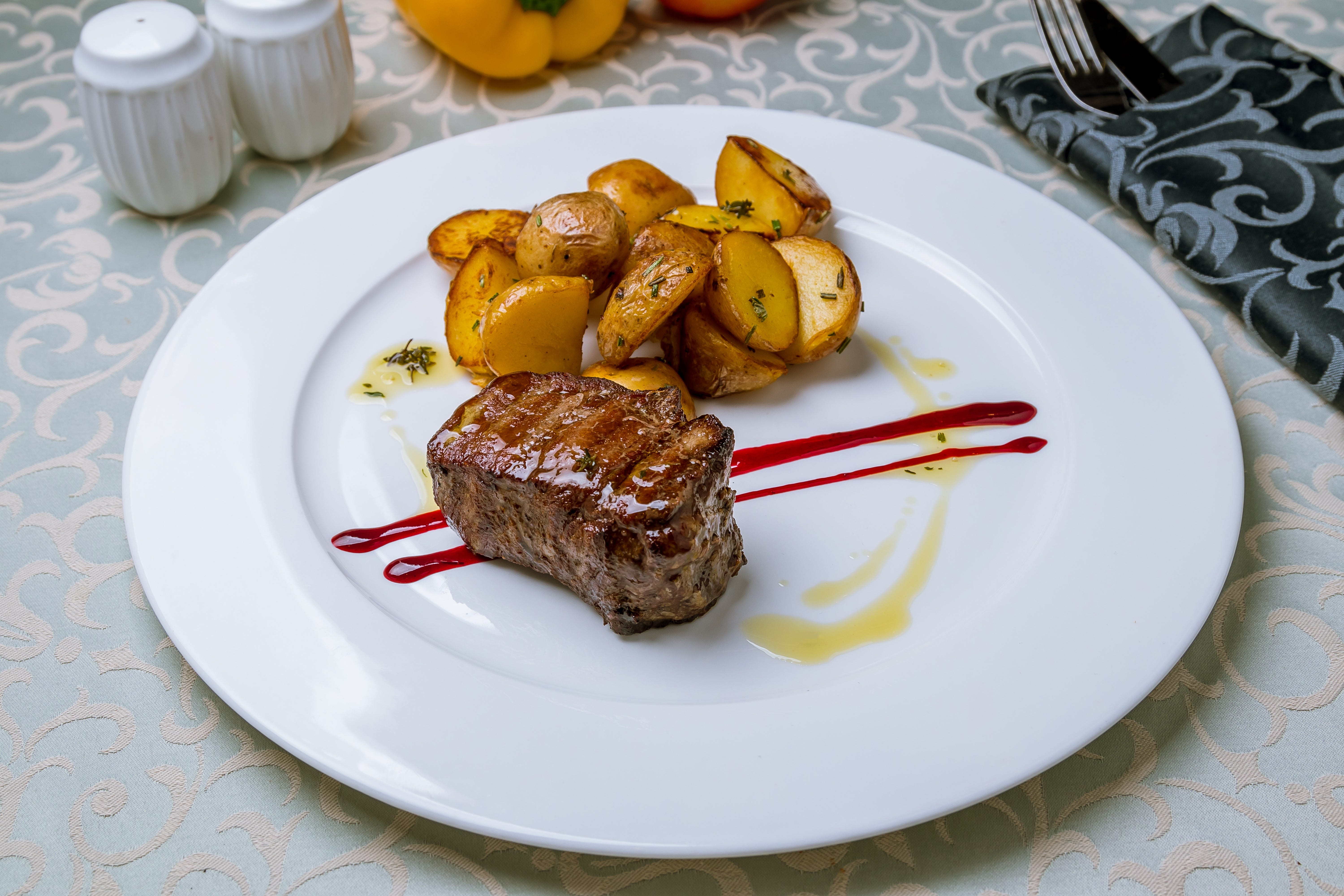 grilled steak filet Mignon on white plate with potatoes