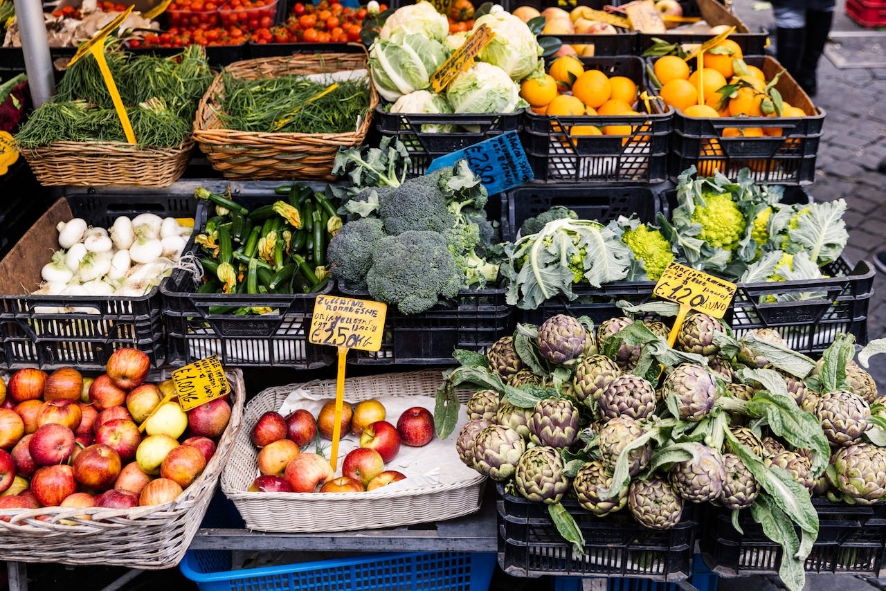 An assortment of fresh fruit and vegetables on sale at a farmers market in Rome.