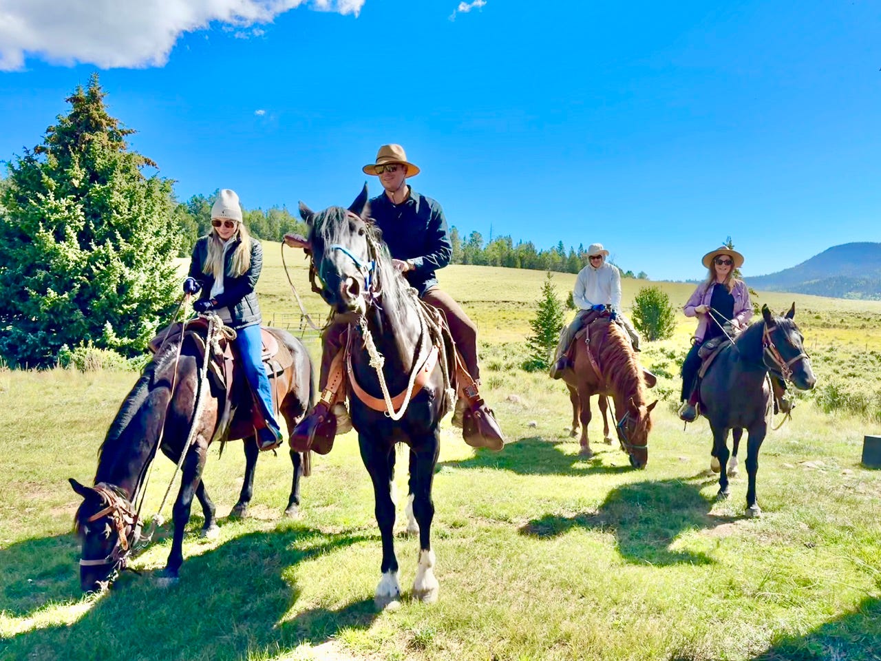 People riding horses in Vermejo