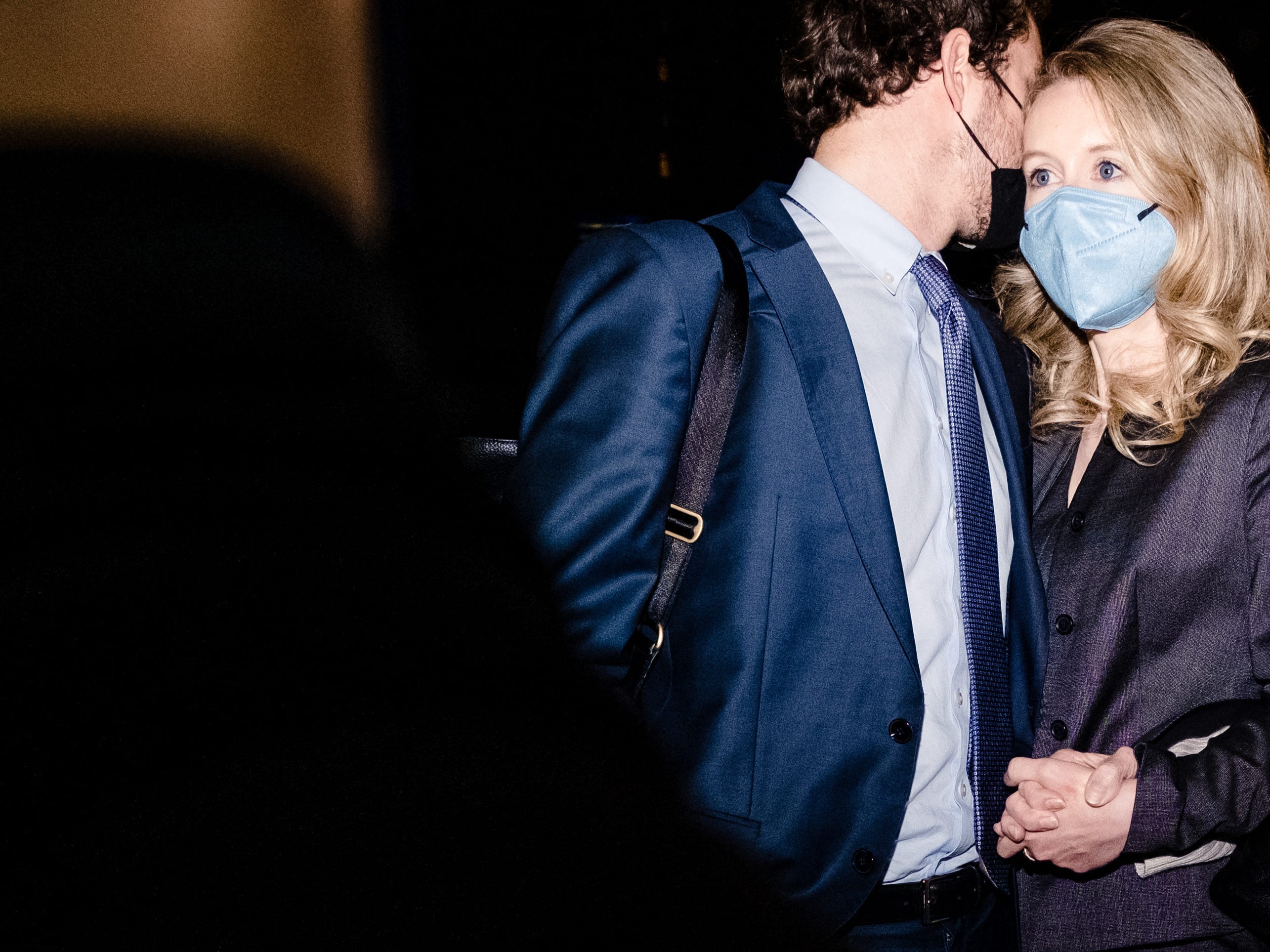 Elizabeth Holmes and partner Billy Evans pause outside of federal court after she was found guilty on 4 of 11 accounts faced in her fraud trial in San Jose, California, January 3, 2022. - Fallen US biotech star Elizabeth Holmes was convicted on Monday of defrauding investors in her blood-testing startup Theranos, in a high-profile case seen as an indictment of Silicon Valley culture. Jurors took seven days of deliberations to reach their verdict, finding her guilty of four counts of tricking investors into pouring money into what she claimed was a revolutionary testing system.
