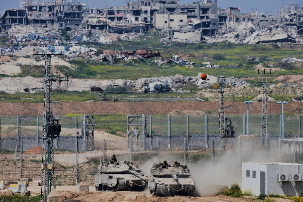 Israeli tanks maneuvering along the northern border of the Gaza Strip, viewed from southern Israel on March 18, 2025.