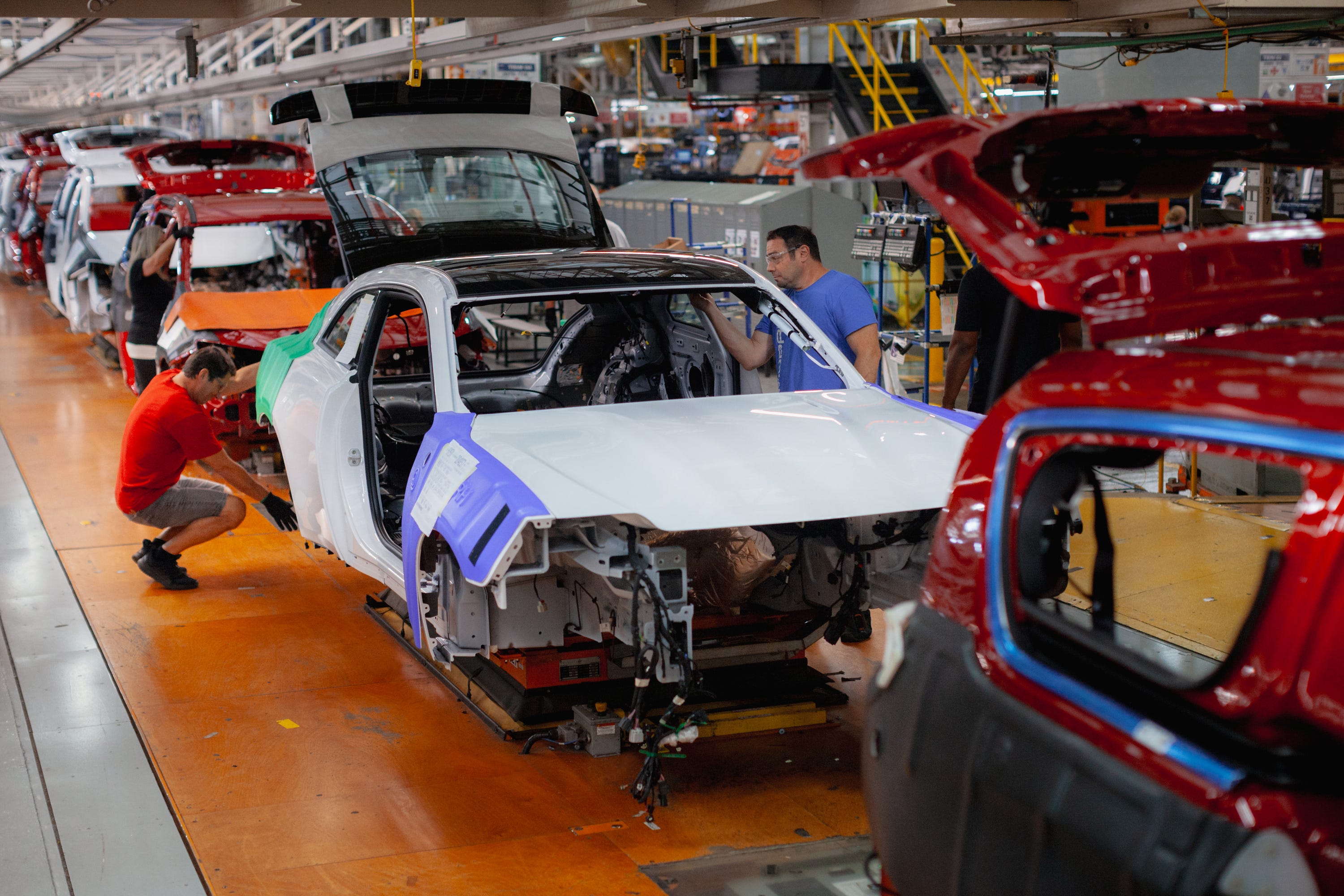 Workers building a Dodge Daytona Charger and Chrysler Pacifica minivans at the Stellantis Windsor Assembly Plant in Canada in September 2024.