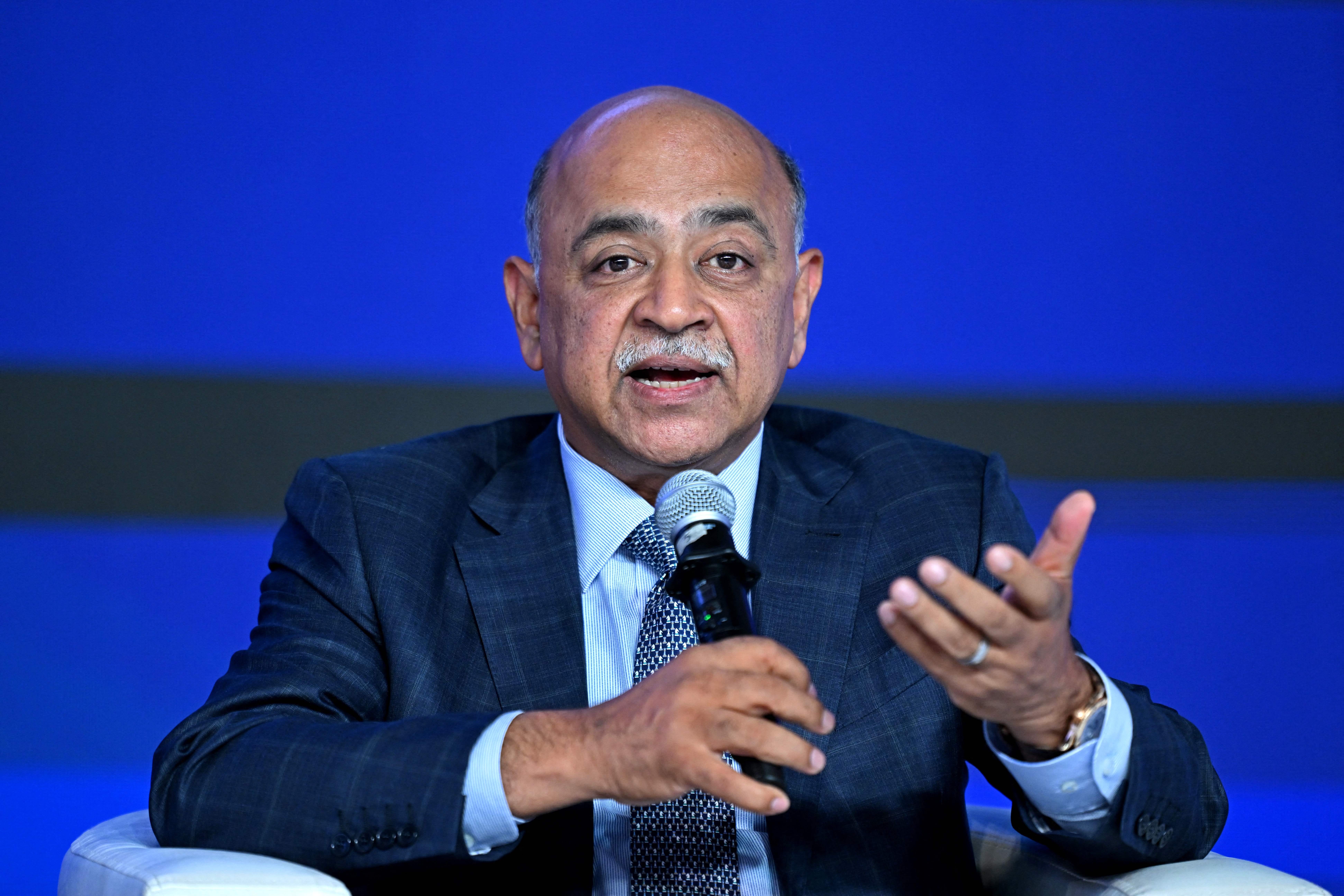 Arvind Krishna holding a microphone