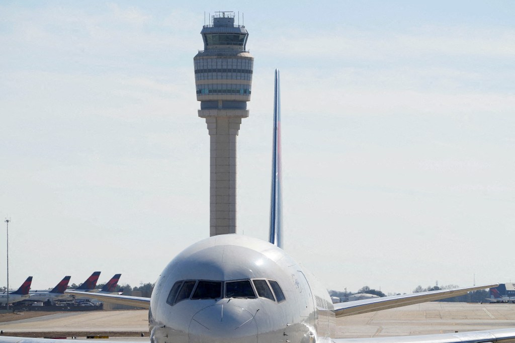 Issues on the runway and with air traffic control hit the Atlanta airport on Sunday, causing hundreds of disruptions at America's busiest airport.