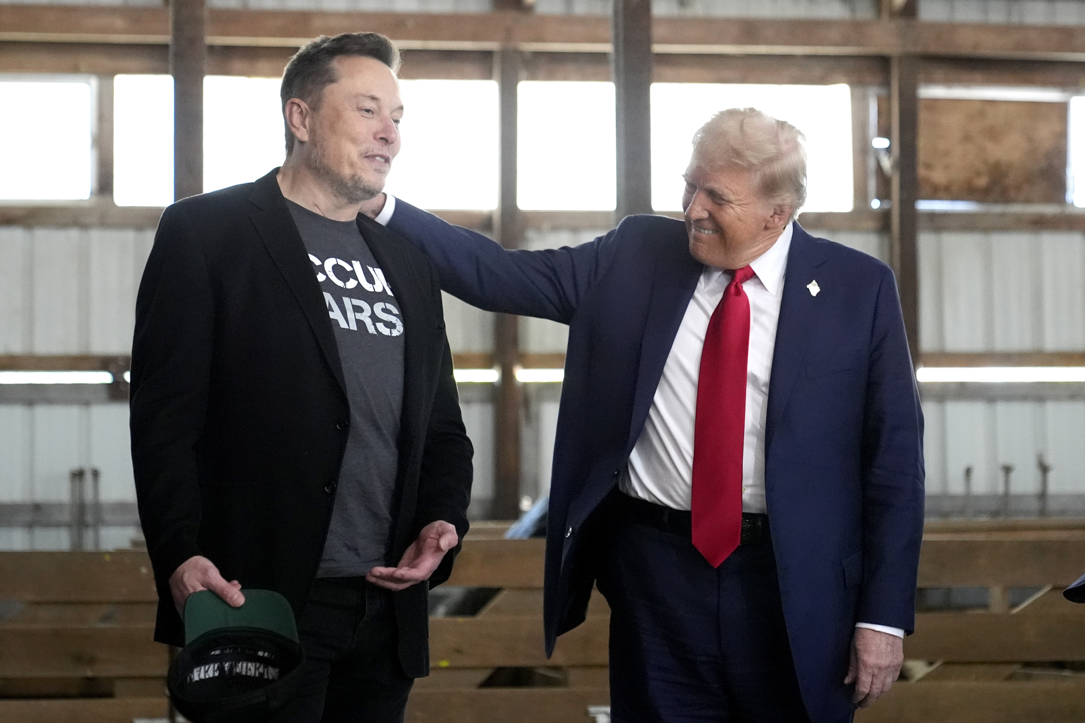 Elon Musk and Donald Trump smiling together. 