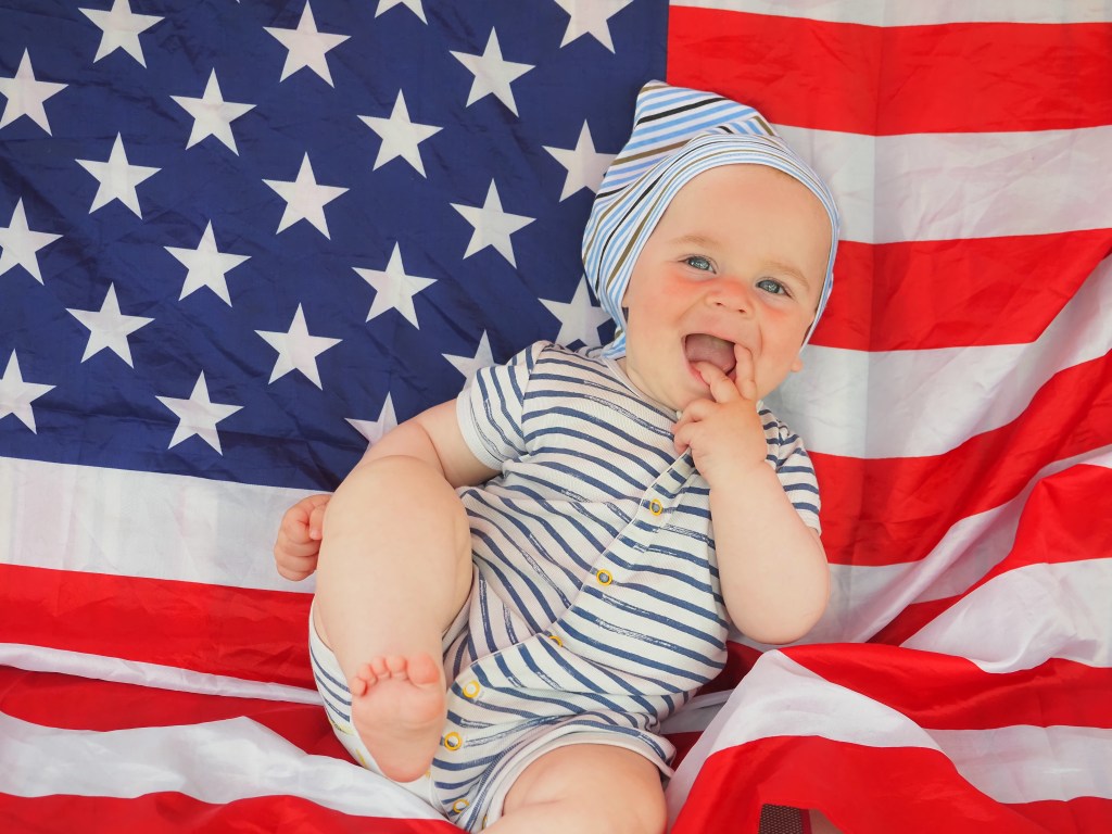 Baby in front of American flag