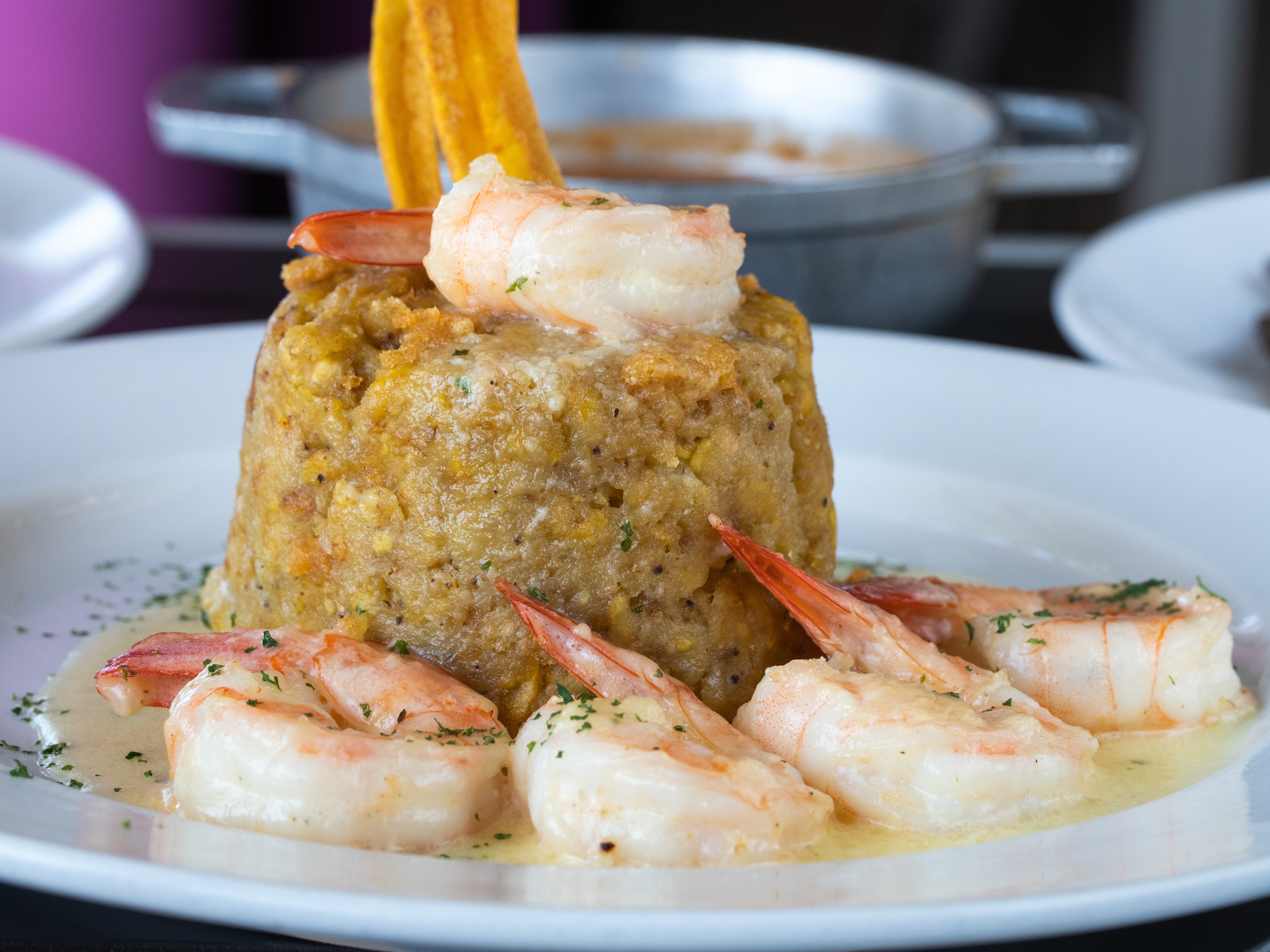 Shrimp mofongo on a white plate.