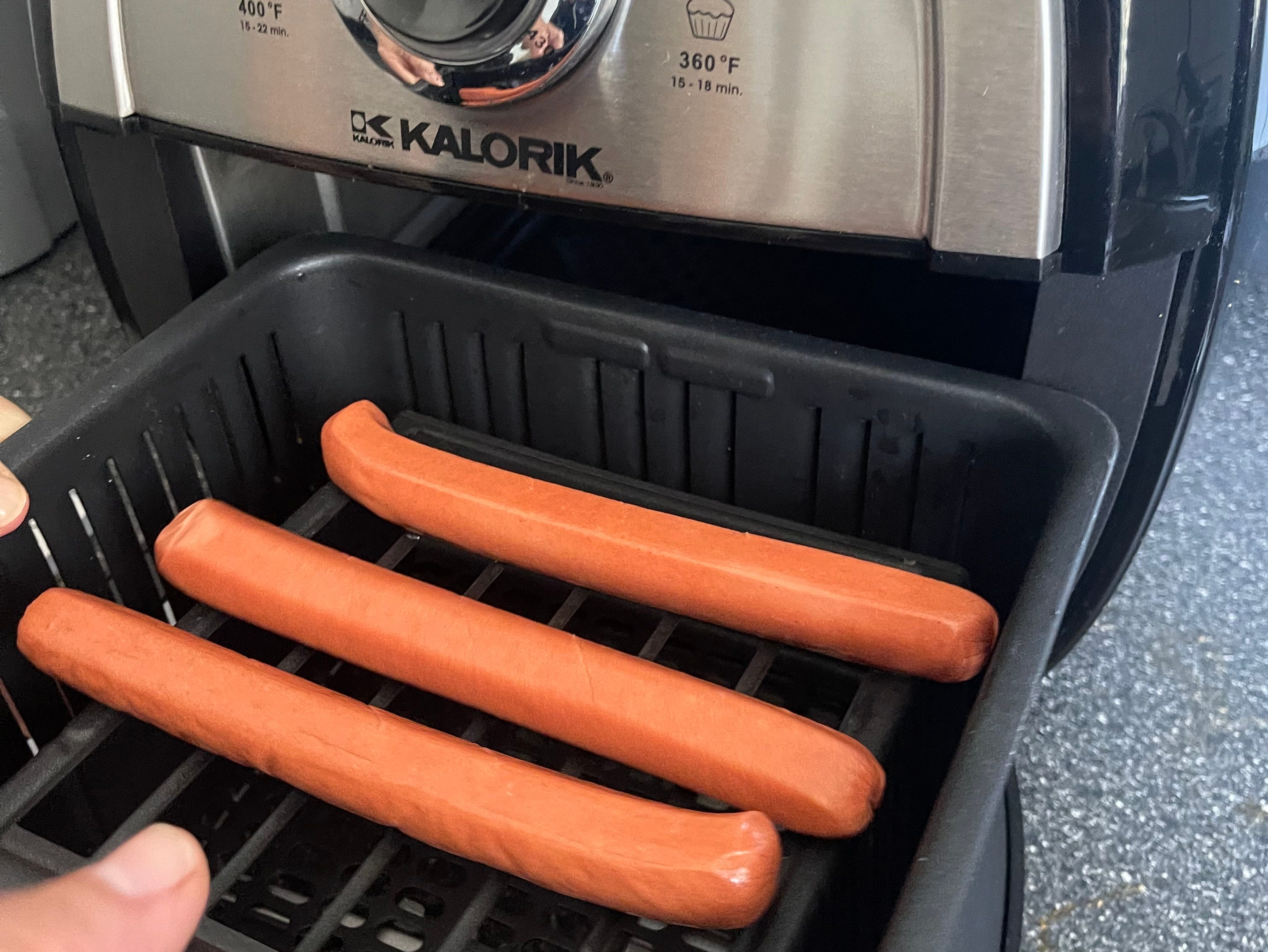 I placed three hot dogs in the air fryer's basket.
