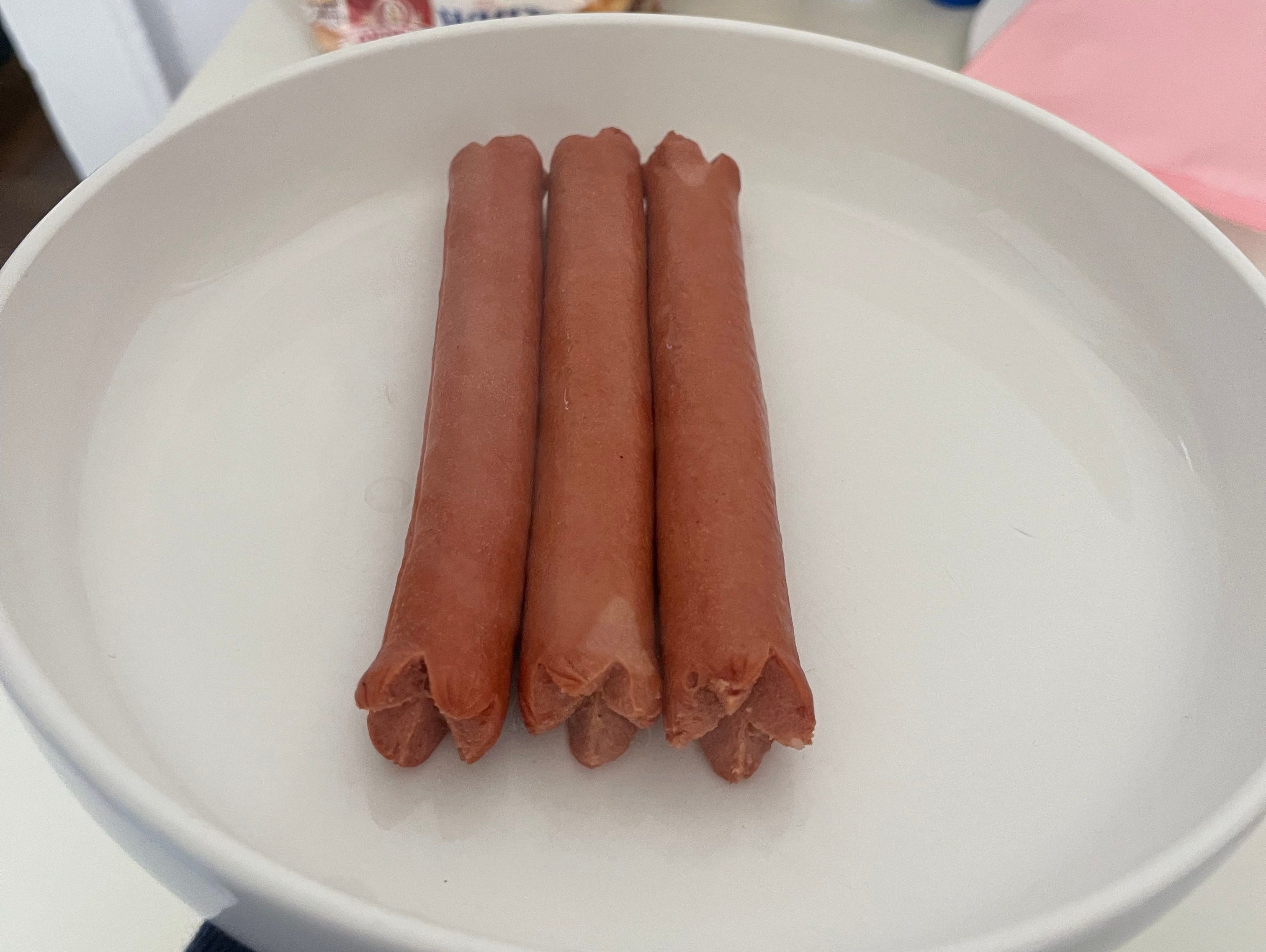 The end result of boiling three hot dogs.
