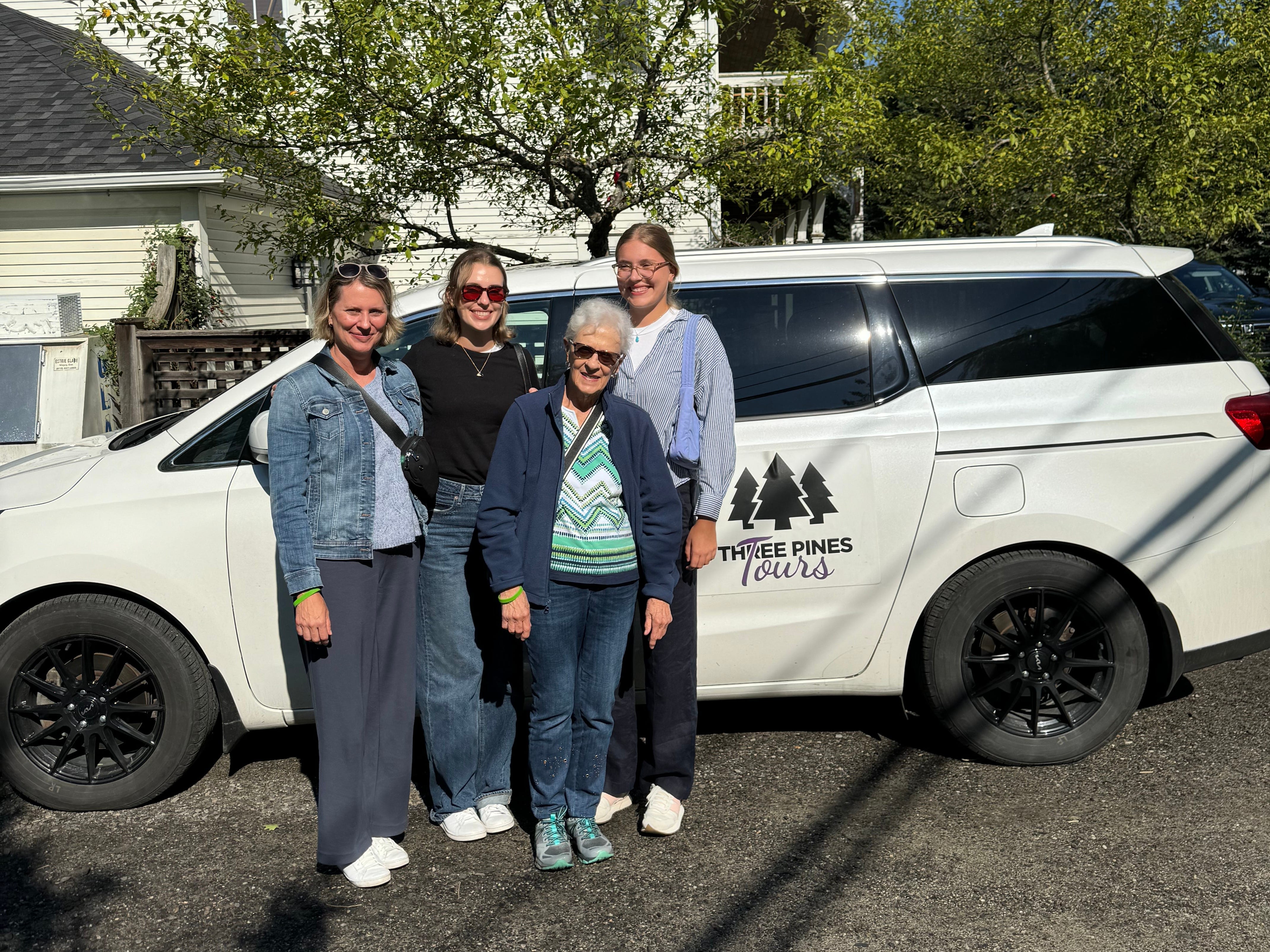 The author and her family posing in front of a white van marked "Three Pines Tours."