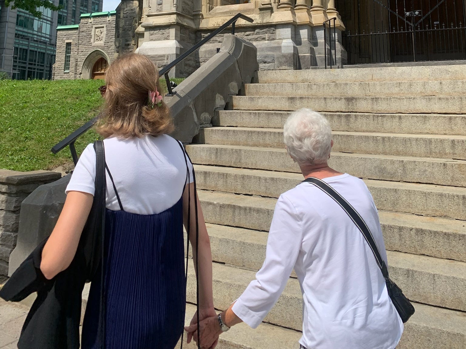 The author holding hands with her grandma as they walked. Their backs are toward the camera.