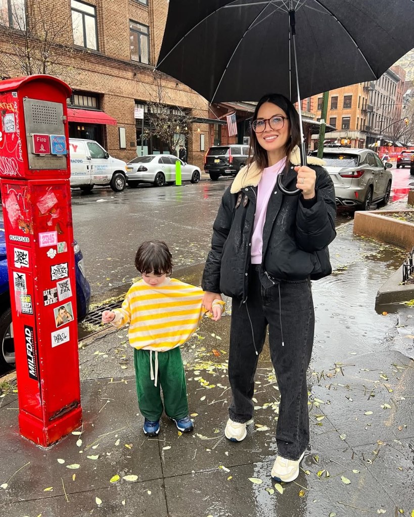 Olivia Munn holding hands with son Malcolm. 