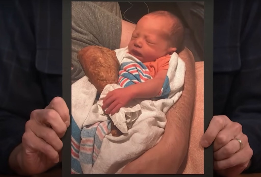 Malcolm holding a drumstick. 