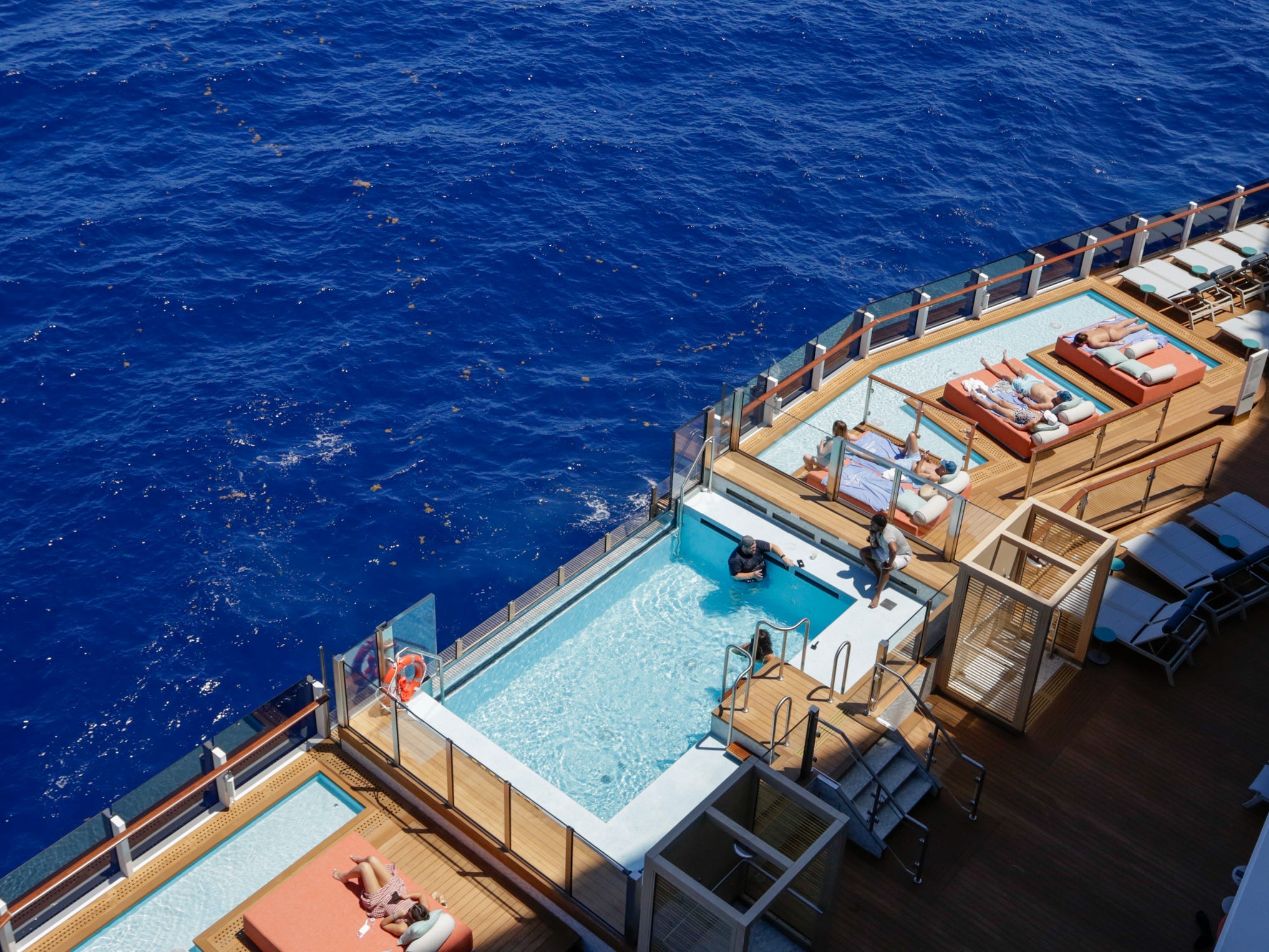 infinity pools and people lounging at Ocean Boulevard on Norwegian Aqua
