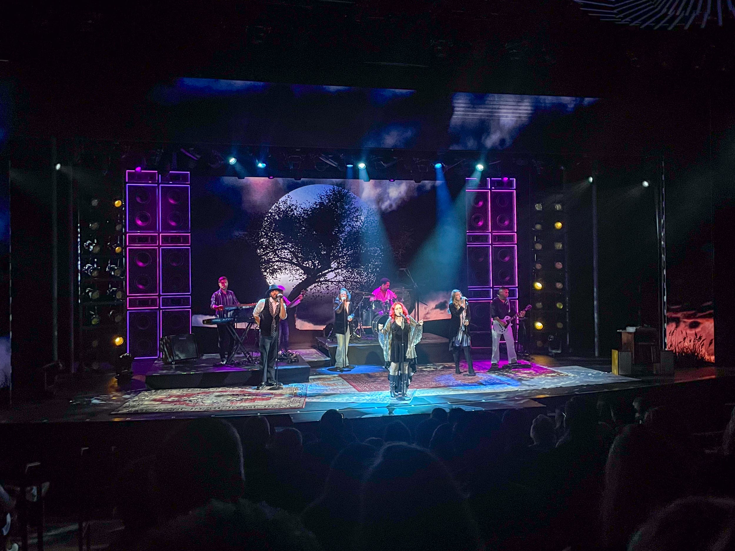 people singing on stage for Syd Norman's Presents: Rumours on Norwegian Aqua