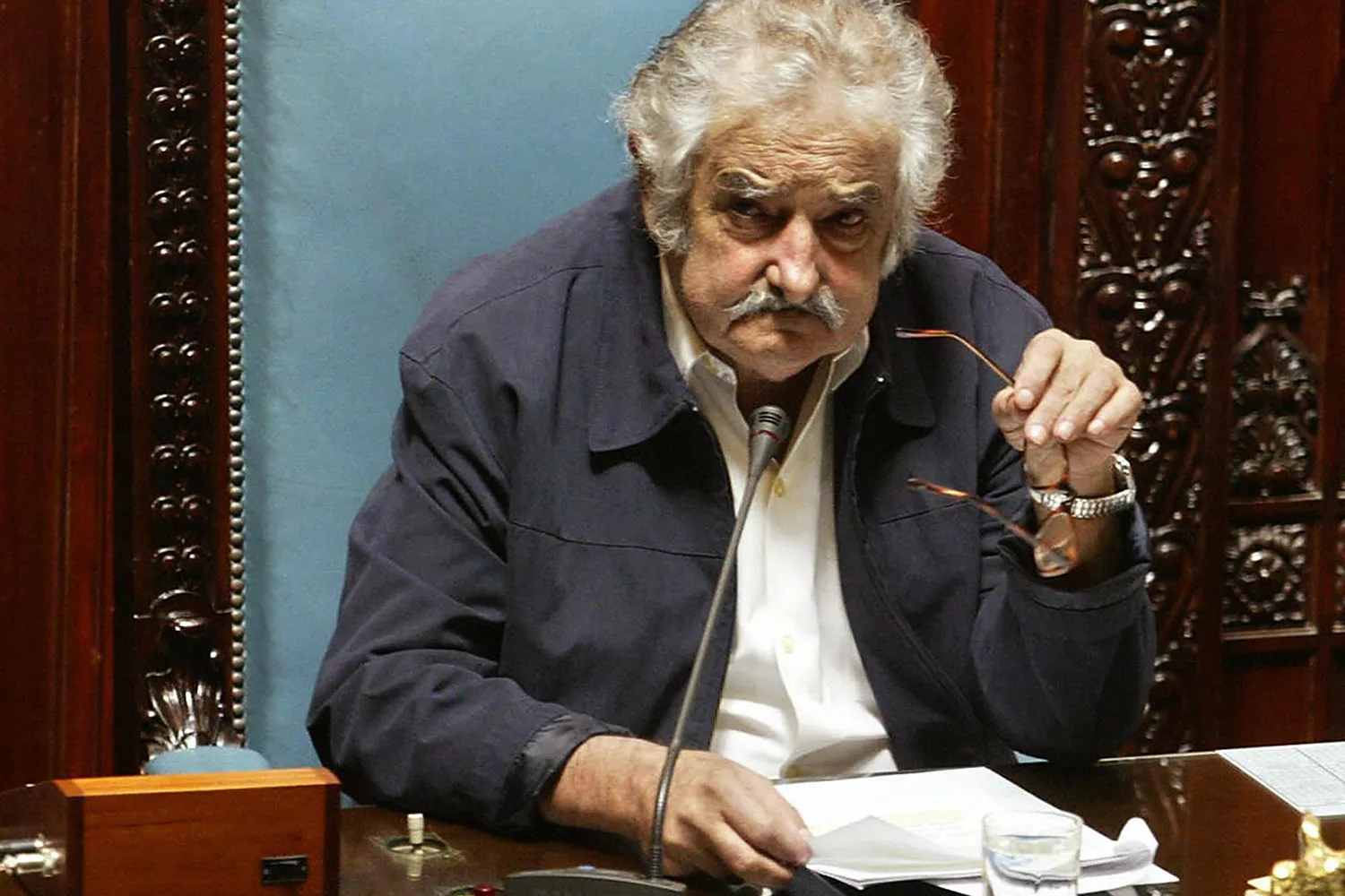 José Mujica sits at a desk.